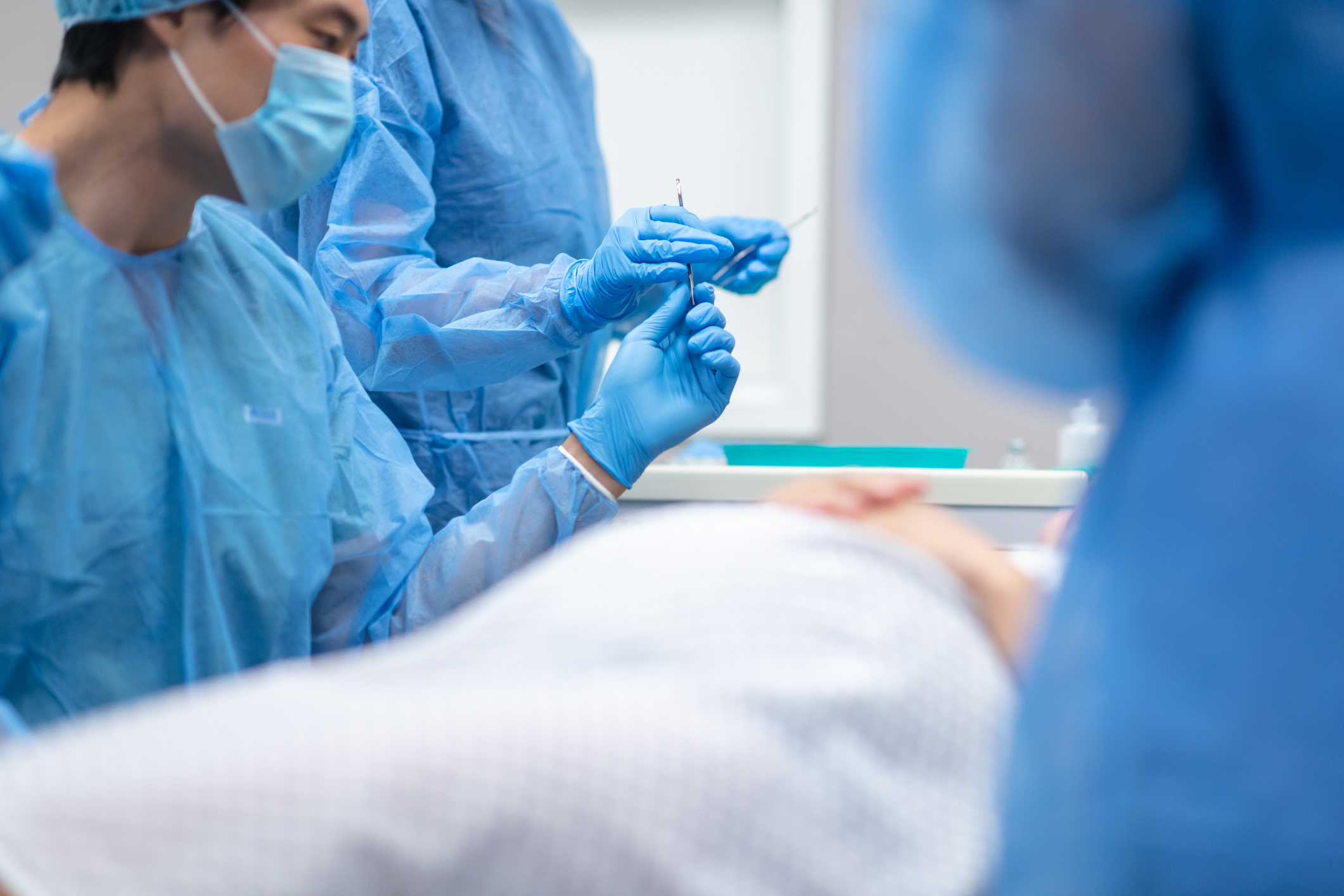 Pregnant woman lays on operating table before receiving cesarean section
