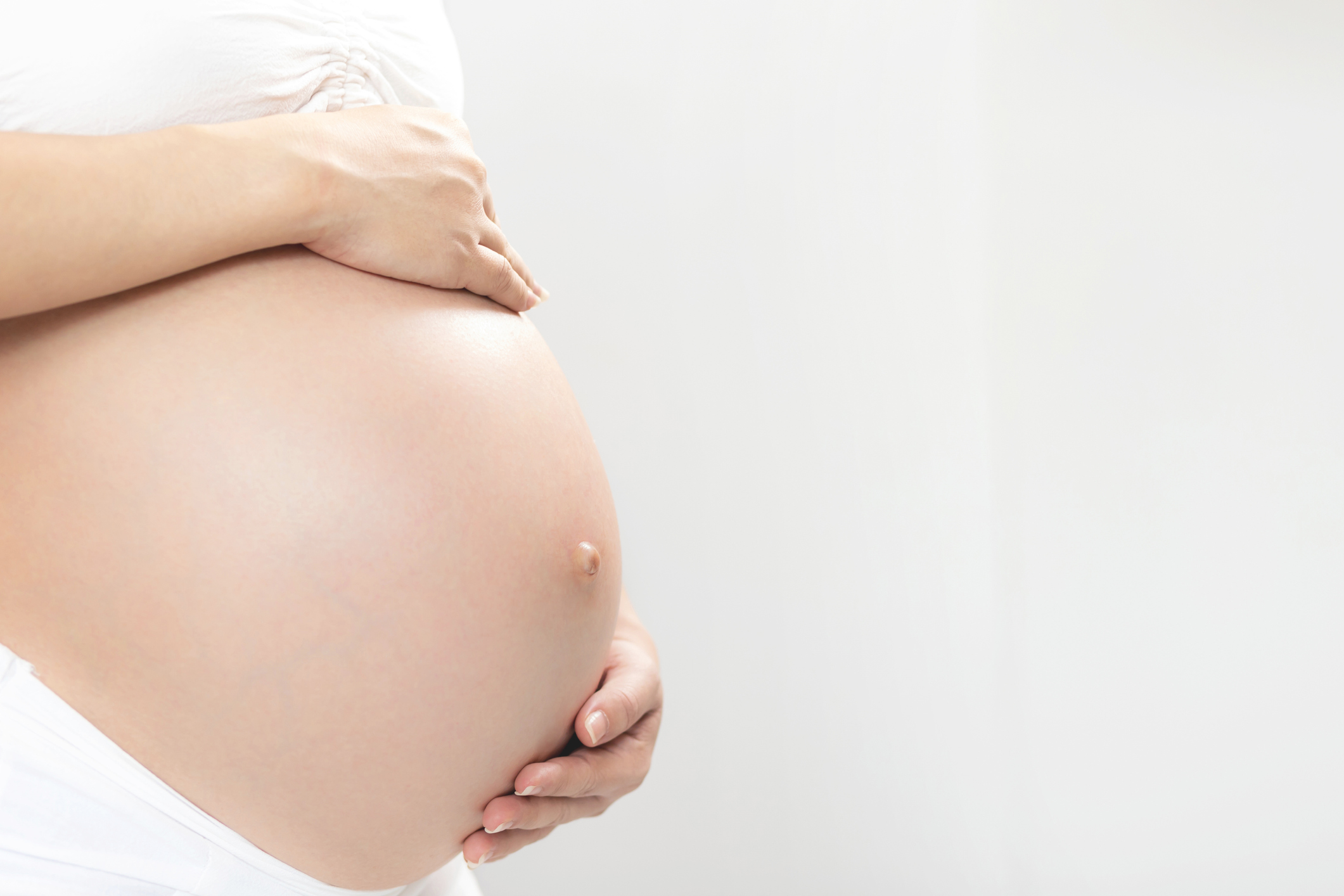 New mom Pregnant woman in white underwear Heart-shaped hand show love with baby