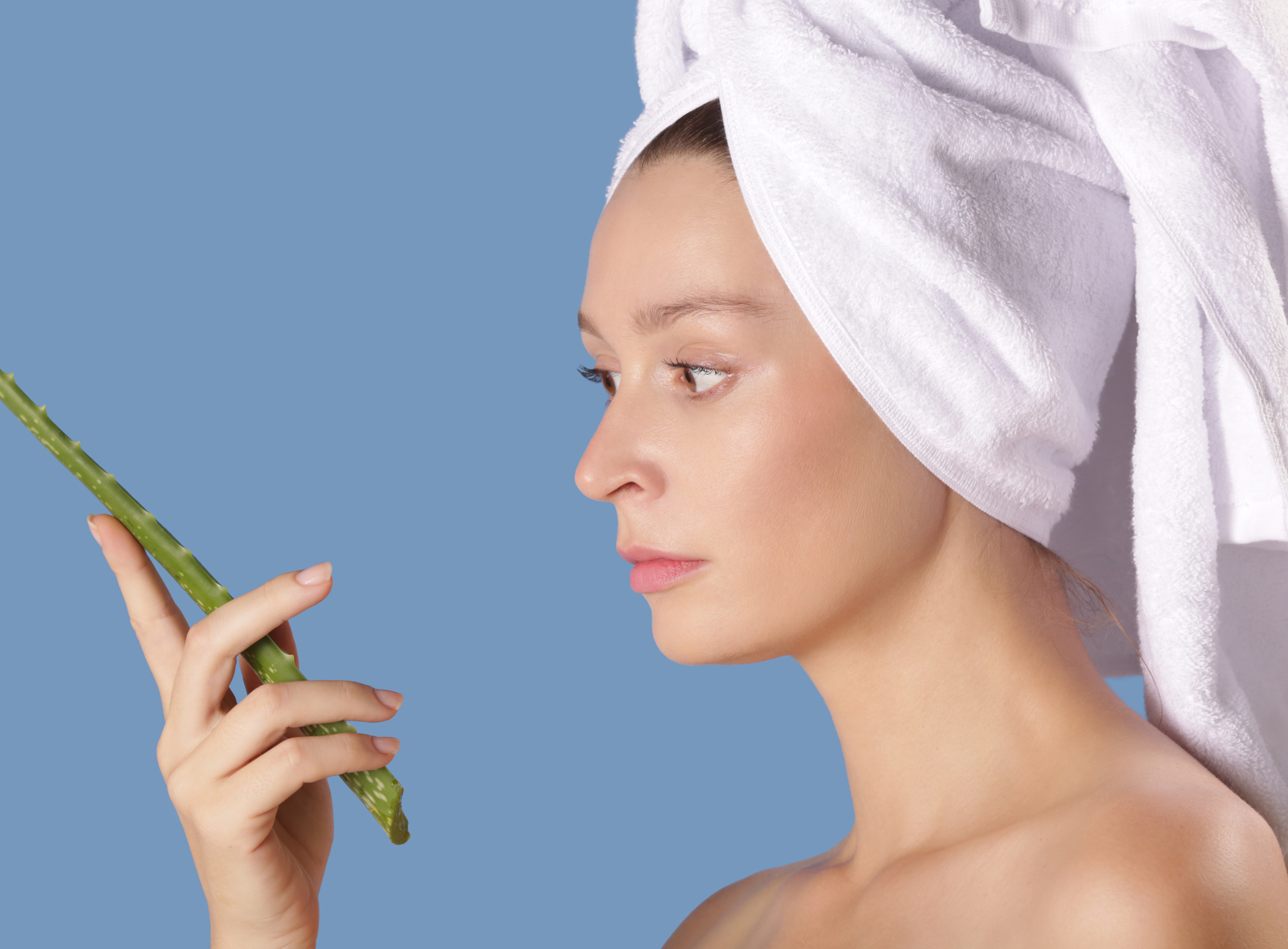 Natural skin beauty. Studio shot of beautiful woman holding aloe vera leaf. Aloe vera benefits for a smoother and wrinkle-free skin concept.