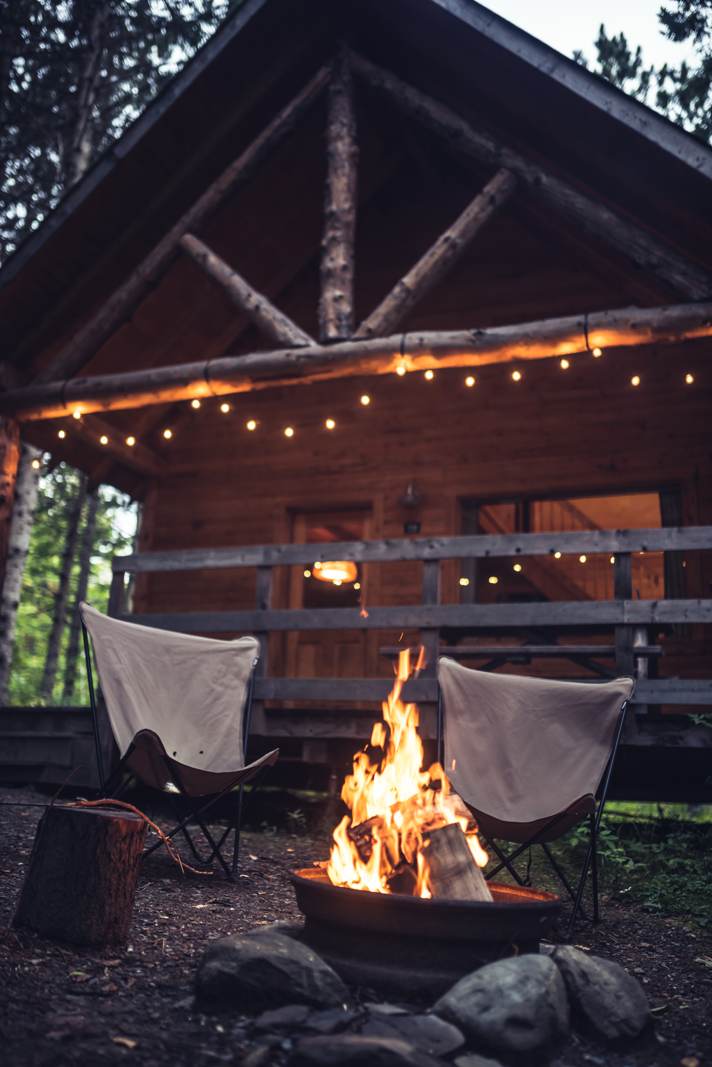 Campfire in front of a rustic house in the forest