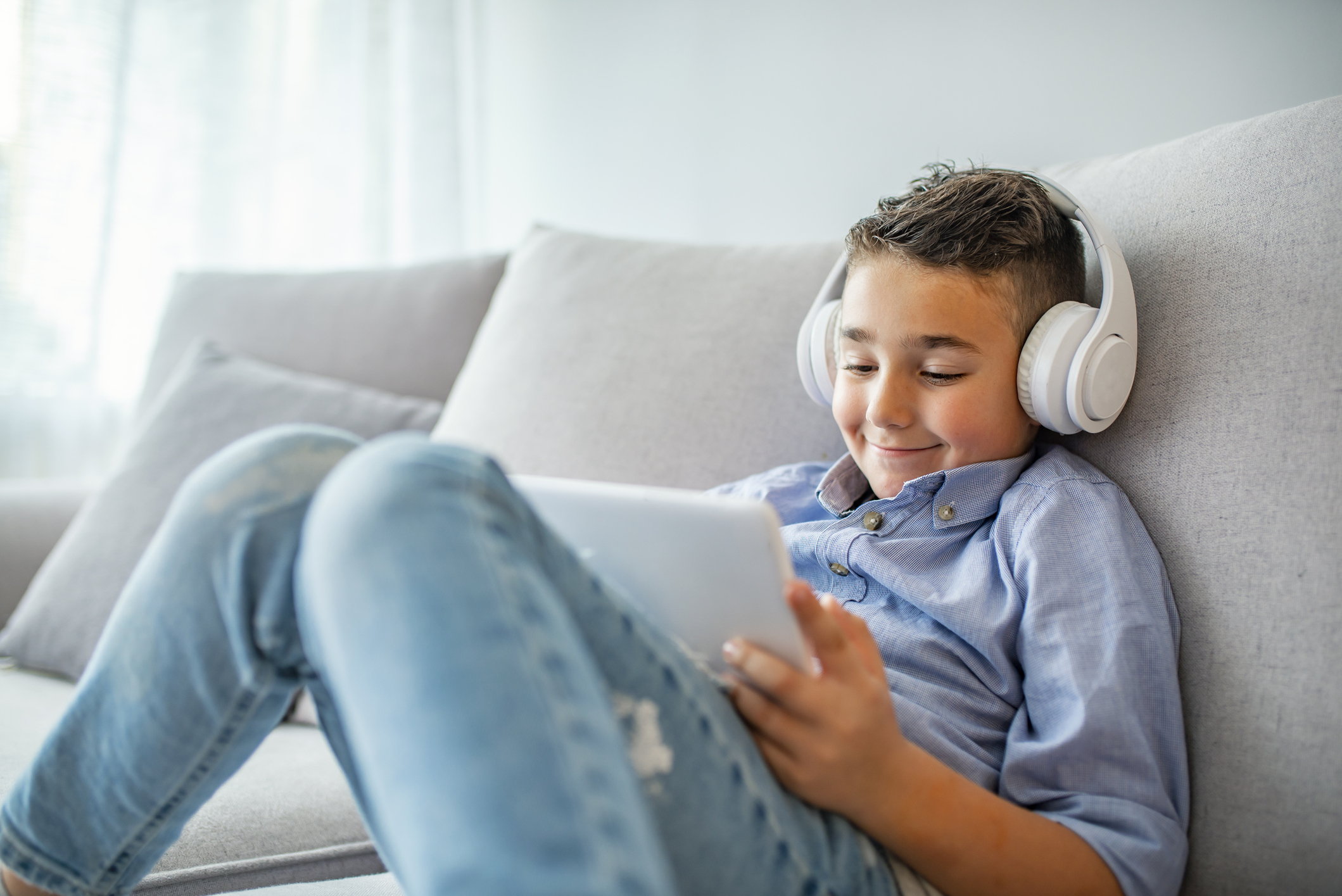 Boy playing with digital tablet.