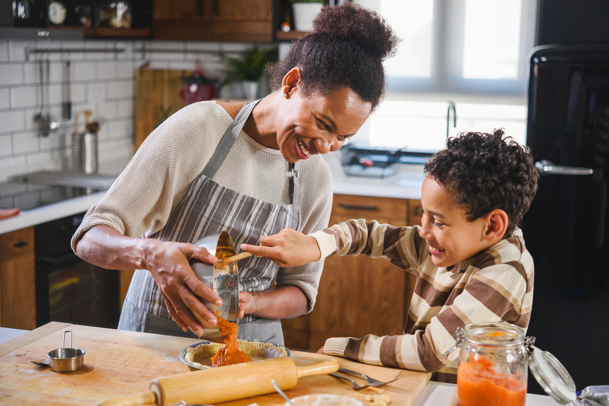 Mother and son baking together