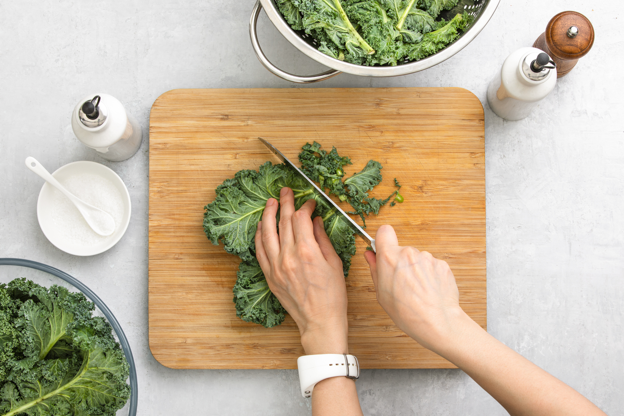 Top down view of fresh kale leaves cut on a cutting board