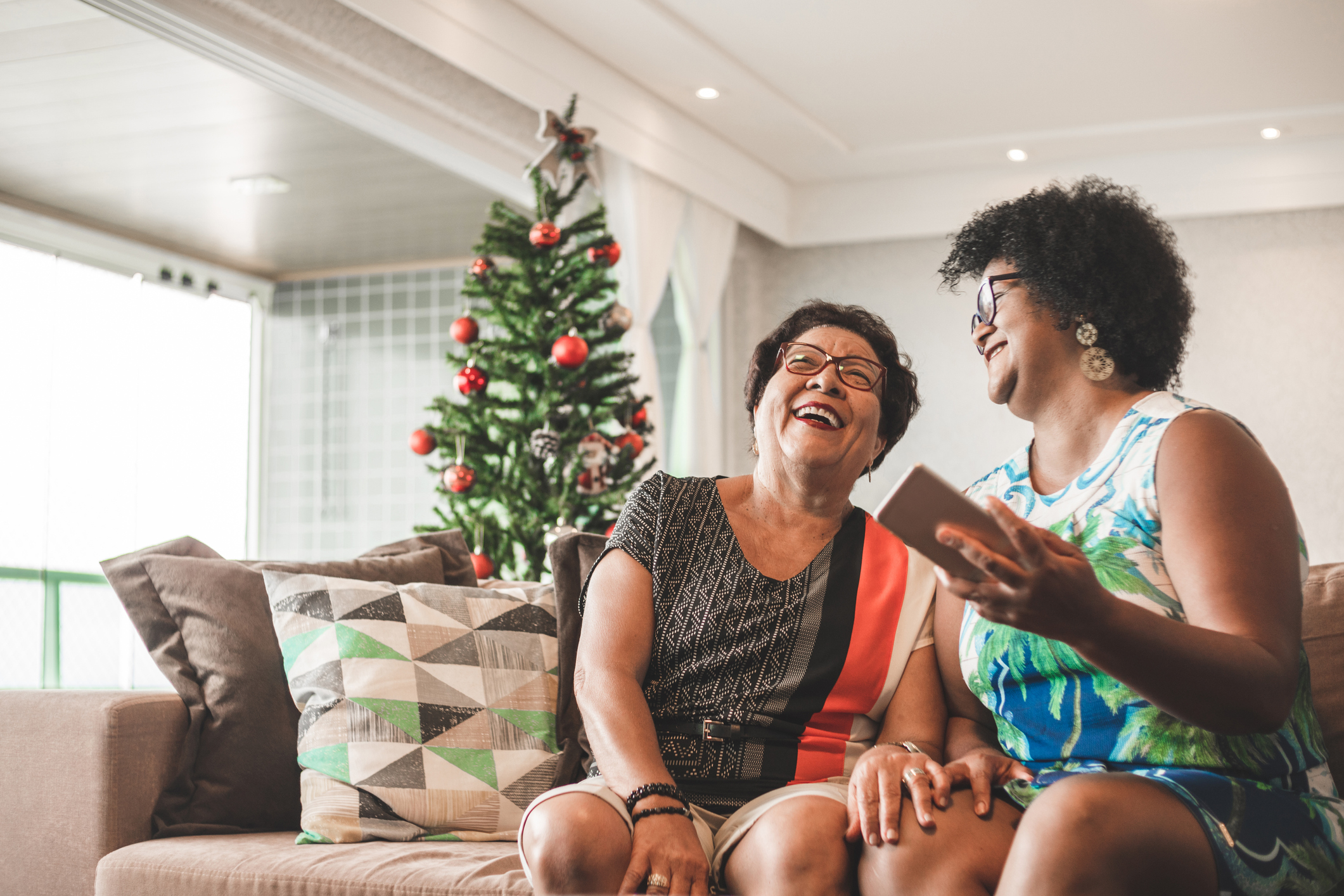 Mother and daughter laughing at home