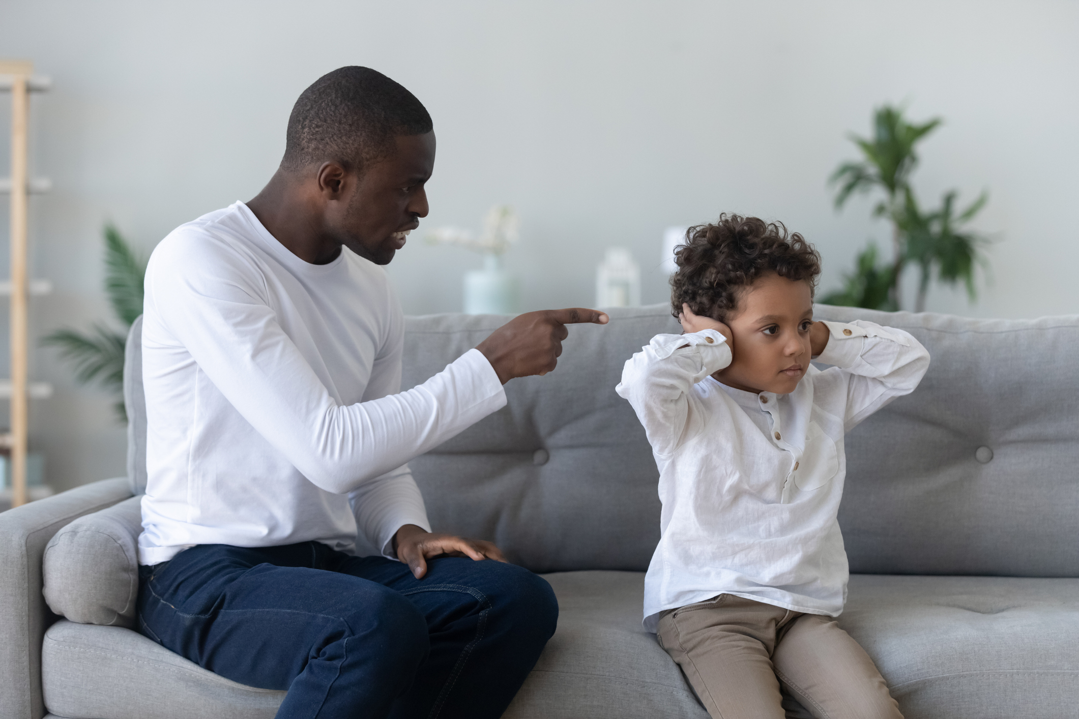 Angry single black father scolding stubborn fussy little african son