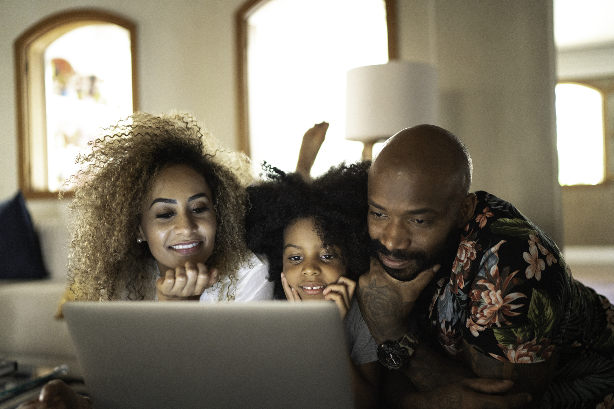 Happy family watching movie on a laptop