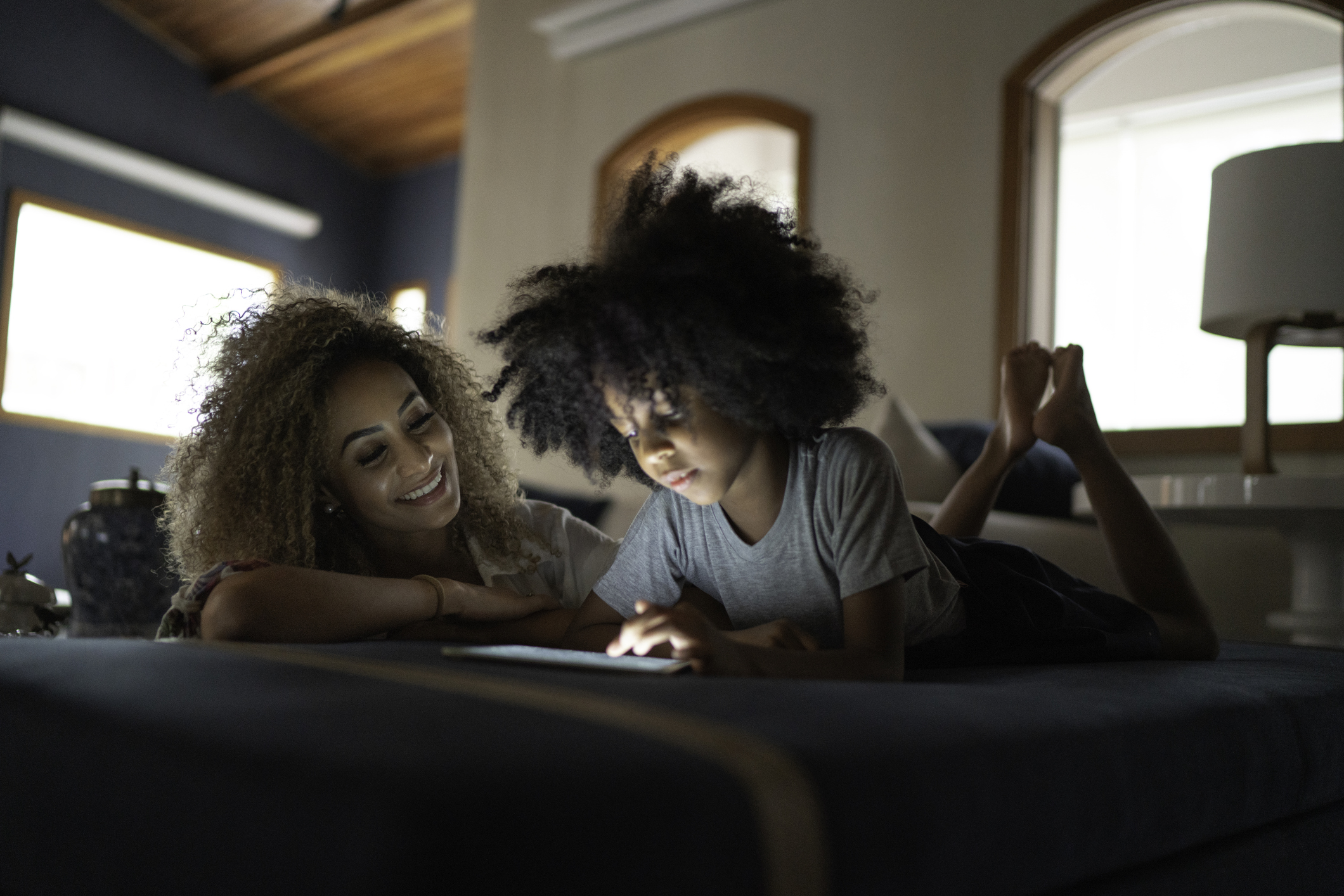 Mother and daughter using digital tablet