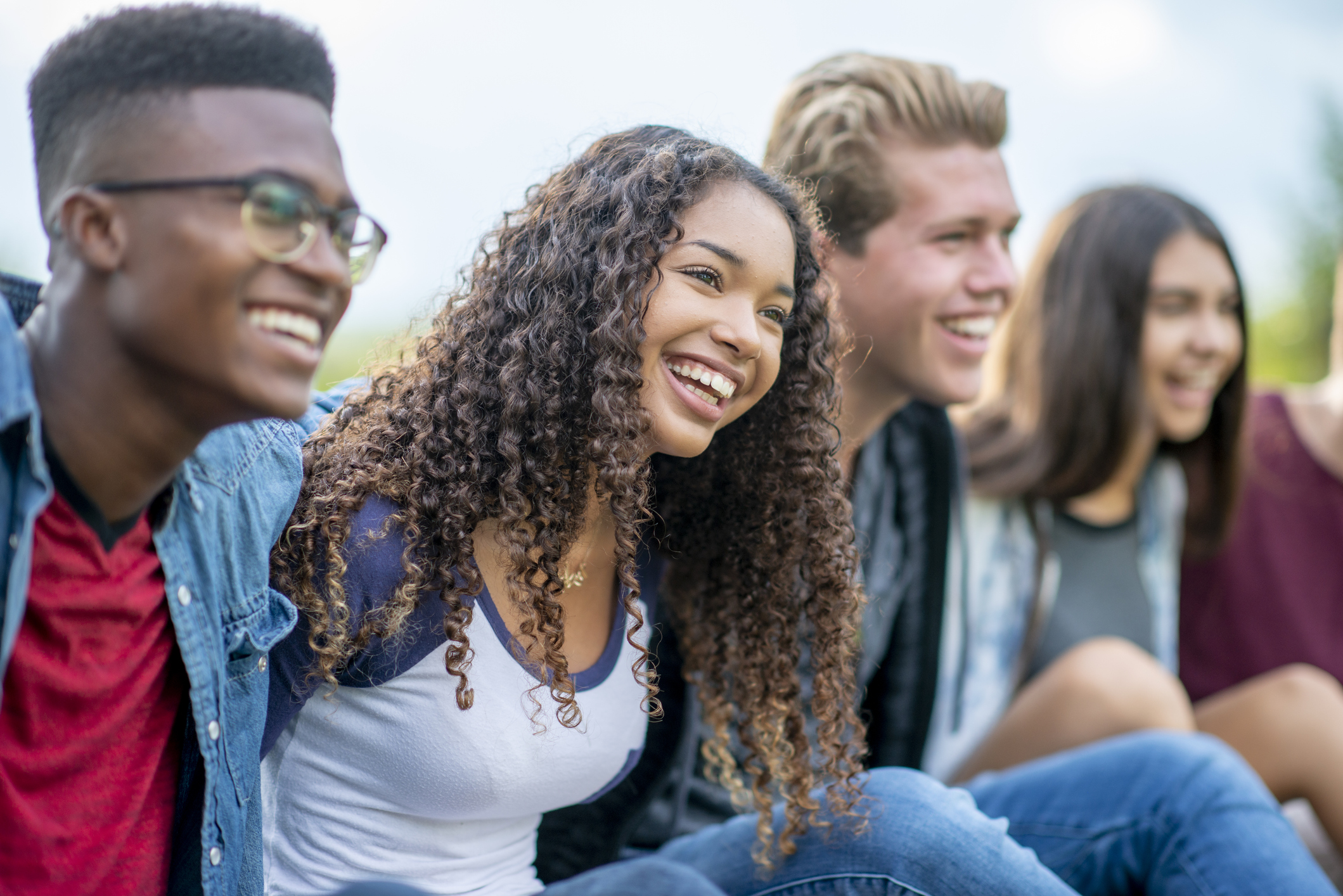 Multi-Ethnic Group of Teenagers Laughing Together Outside stock photo