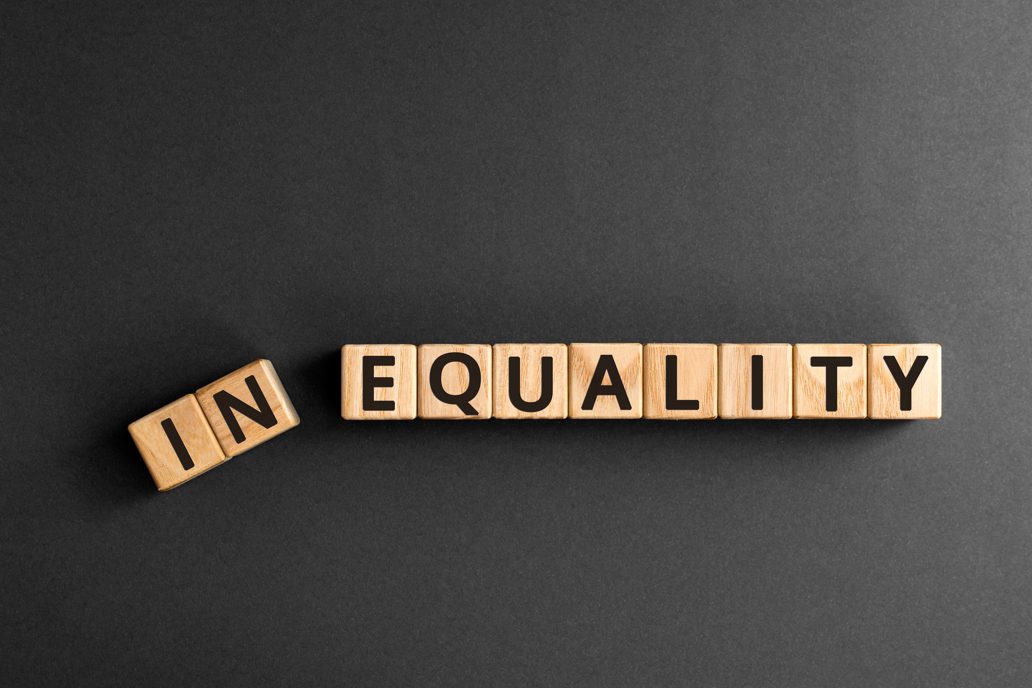 Inequality to equality - word from wooden blocks with letters