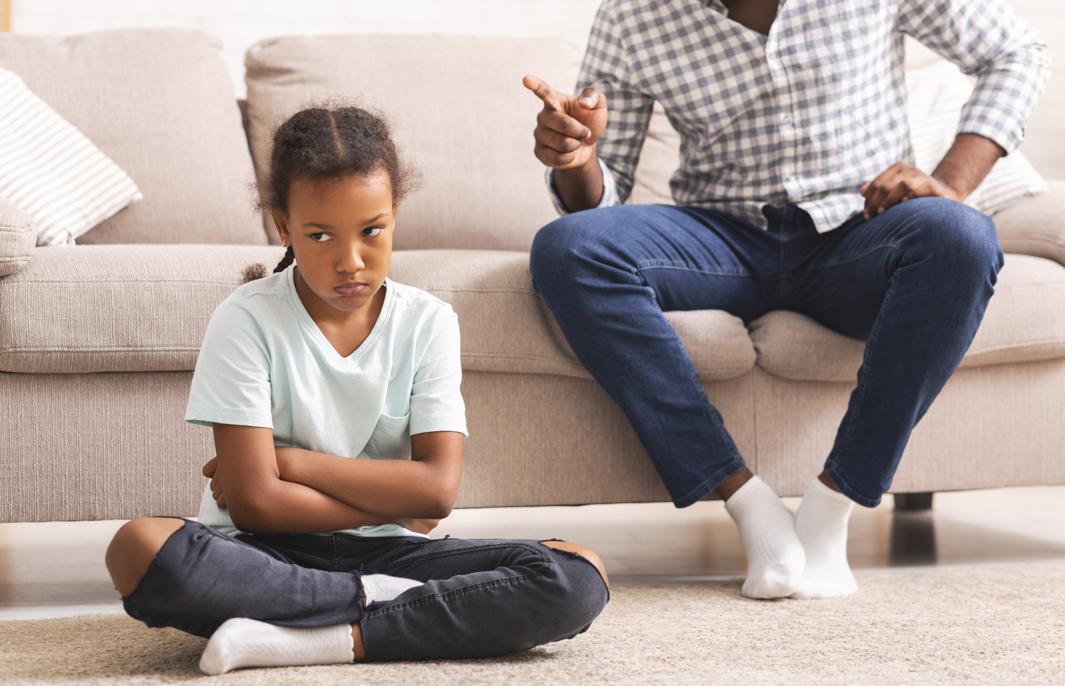 Strict afro father scolding little disobedient daughter for bad behavior