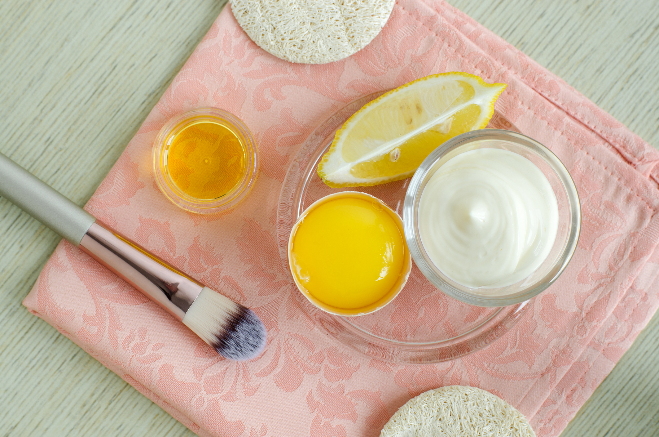 Mayonnaise (greek yogurt, sour cream or kefir), lemon,olive oil and raw egg - ingredients for preparing diy face and hair masks, scrubs and moisturizers. Homemade beauty treatments recipe. Top view.