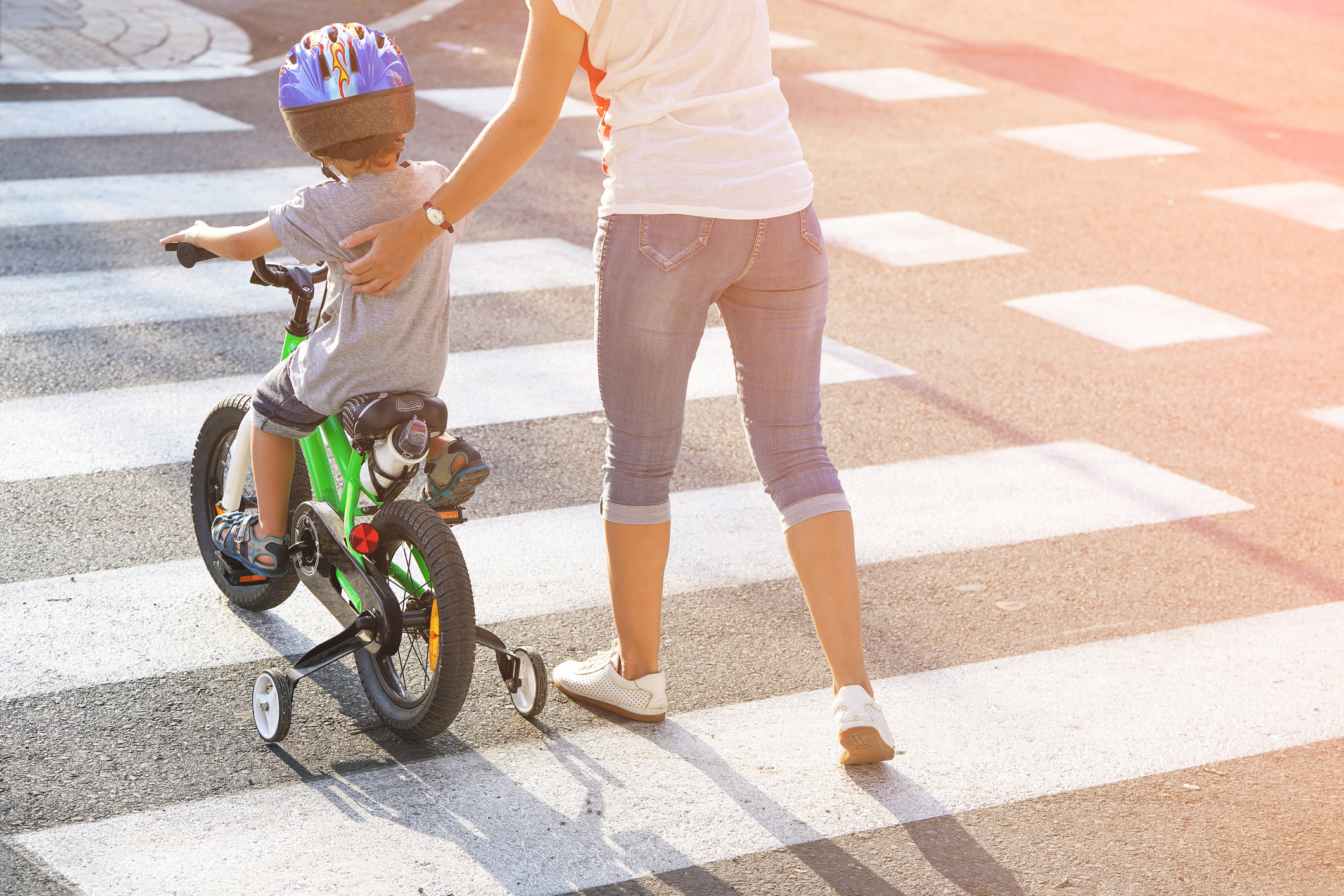 Mother with son with a bike on a zebra