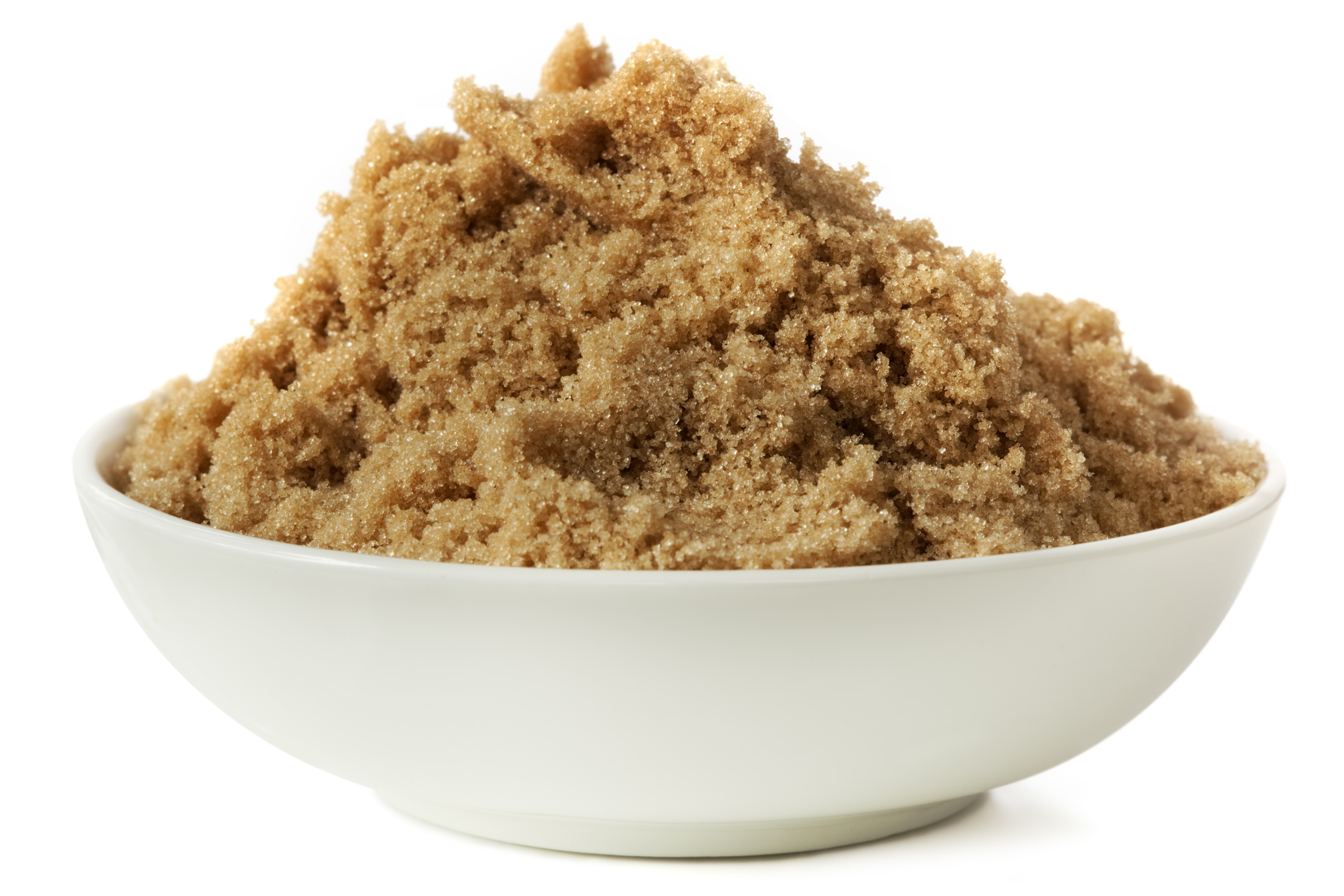 White dish of brown sugar on white background