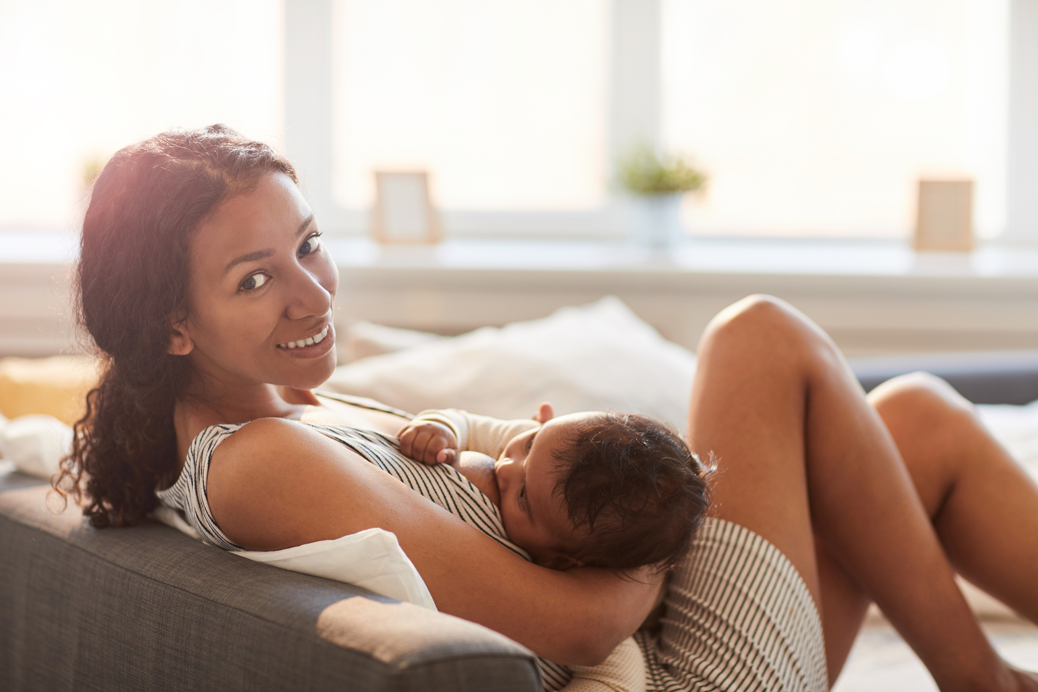 Young Woman Breastfeeding Baby Baby at Home