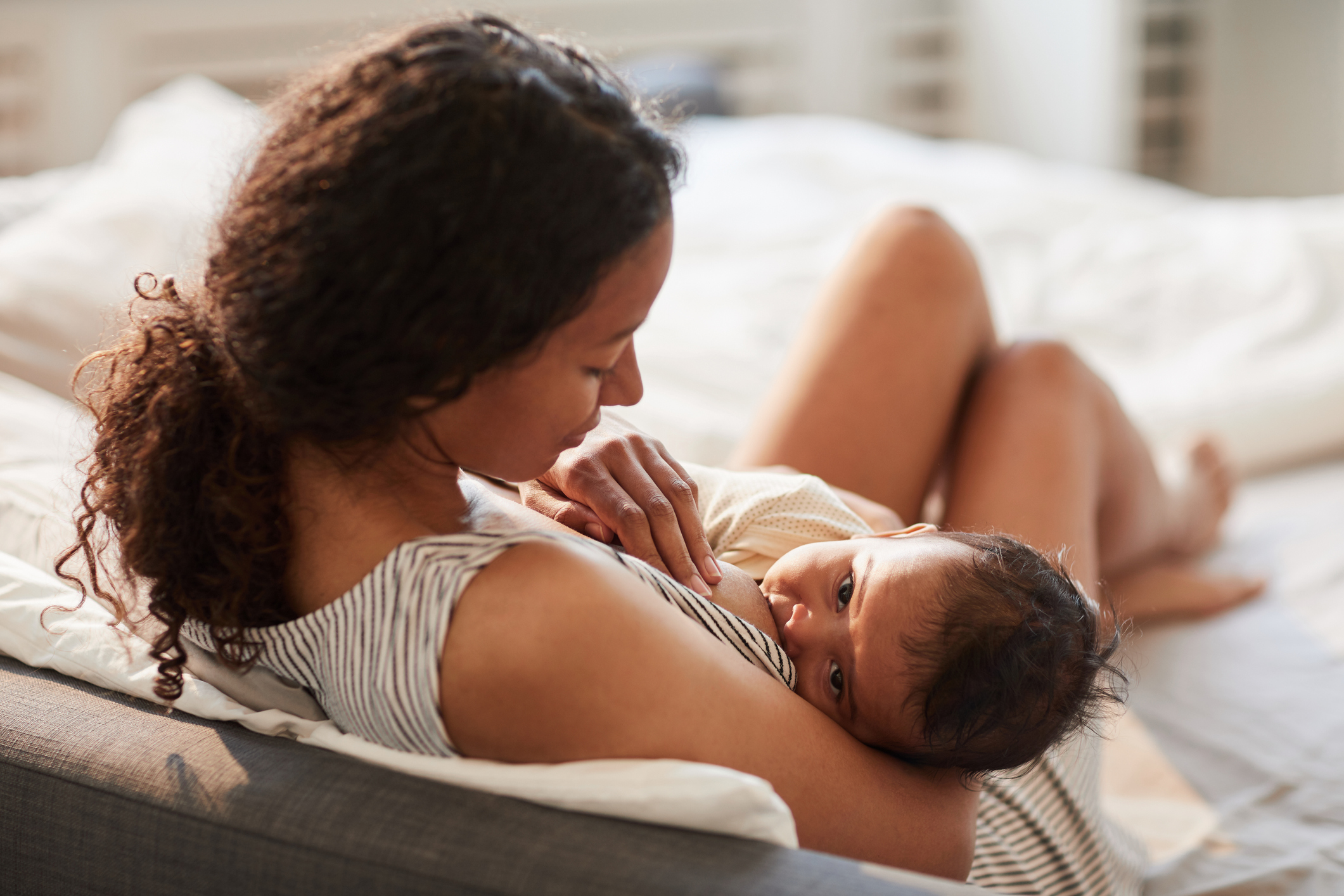 Young Mother Breastfeeding Baby Baby at Home