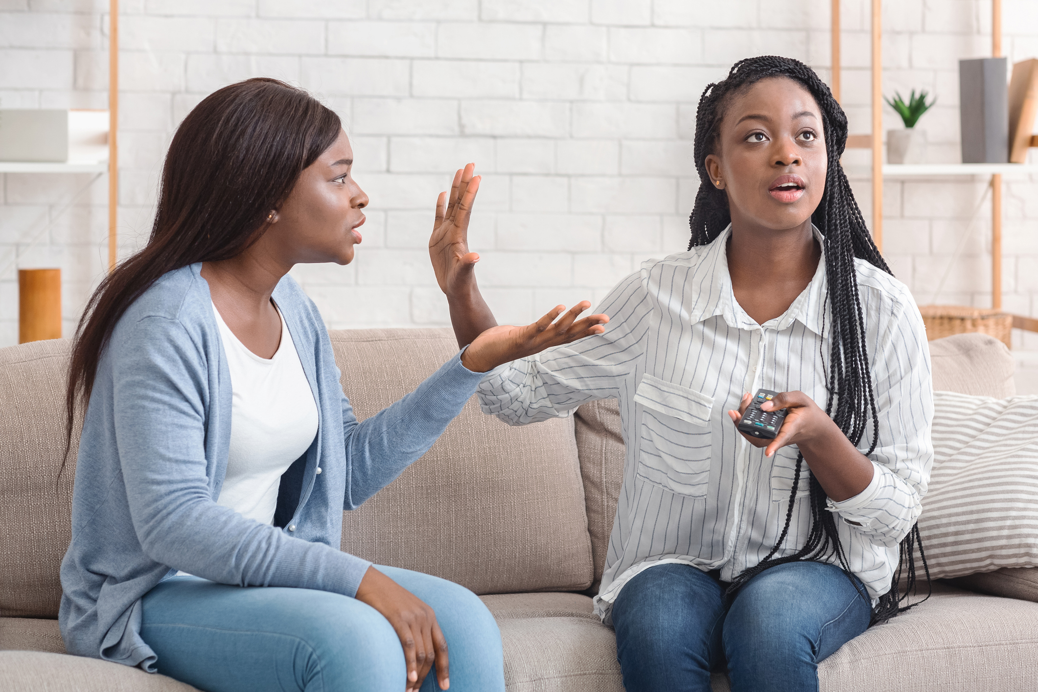 Indifferent Afro Girl Watching TV Not Listening To Her Friend