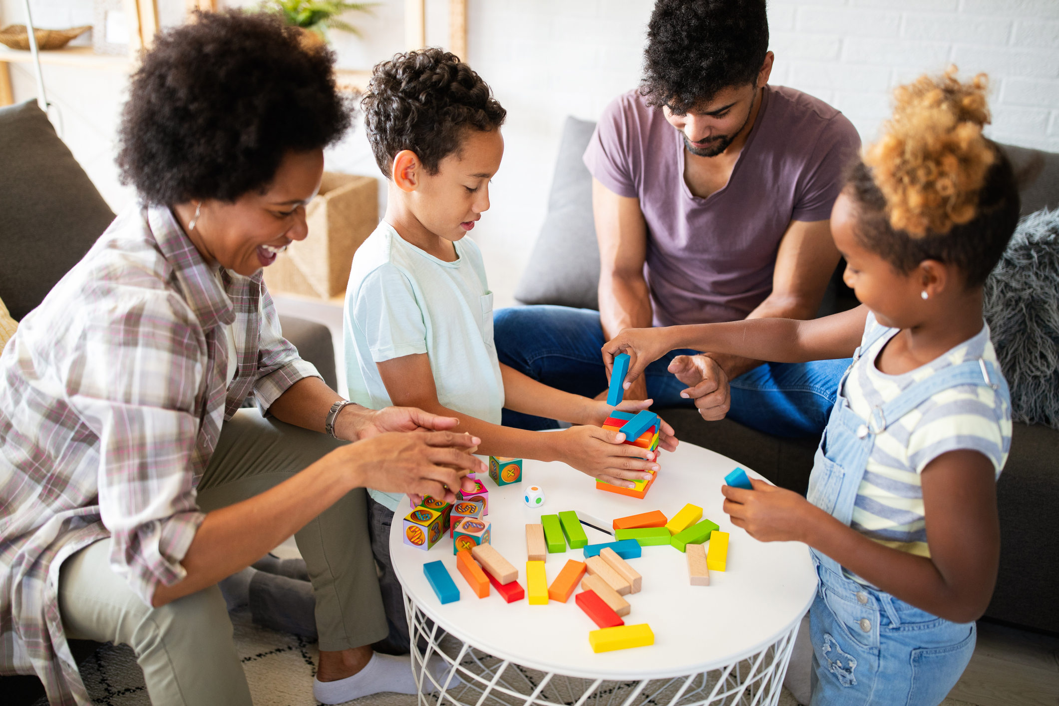 Portrait of black family playing a game at home together