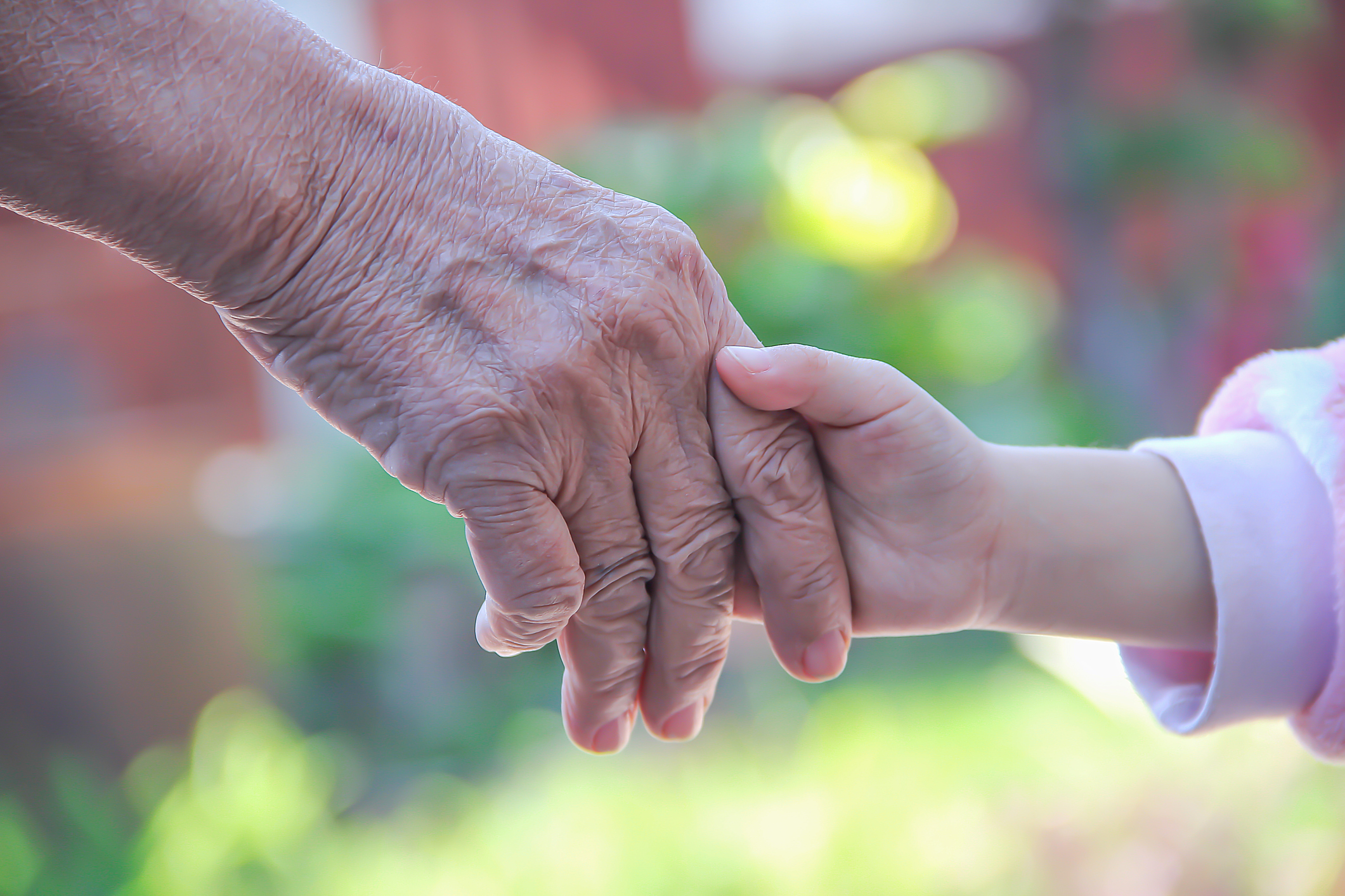 Grandma and grandchild holding hands , Asian two person background