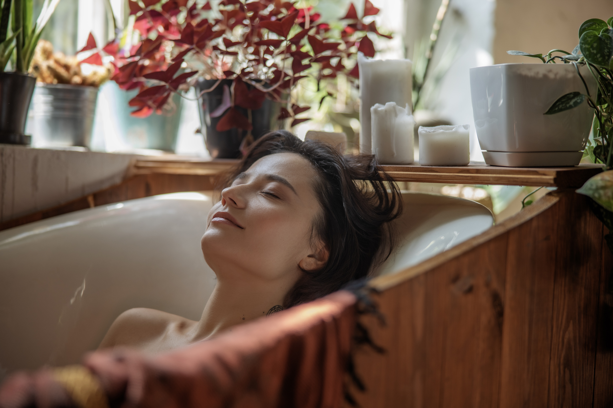 Young woman lying in a bath at home