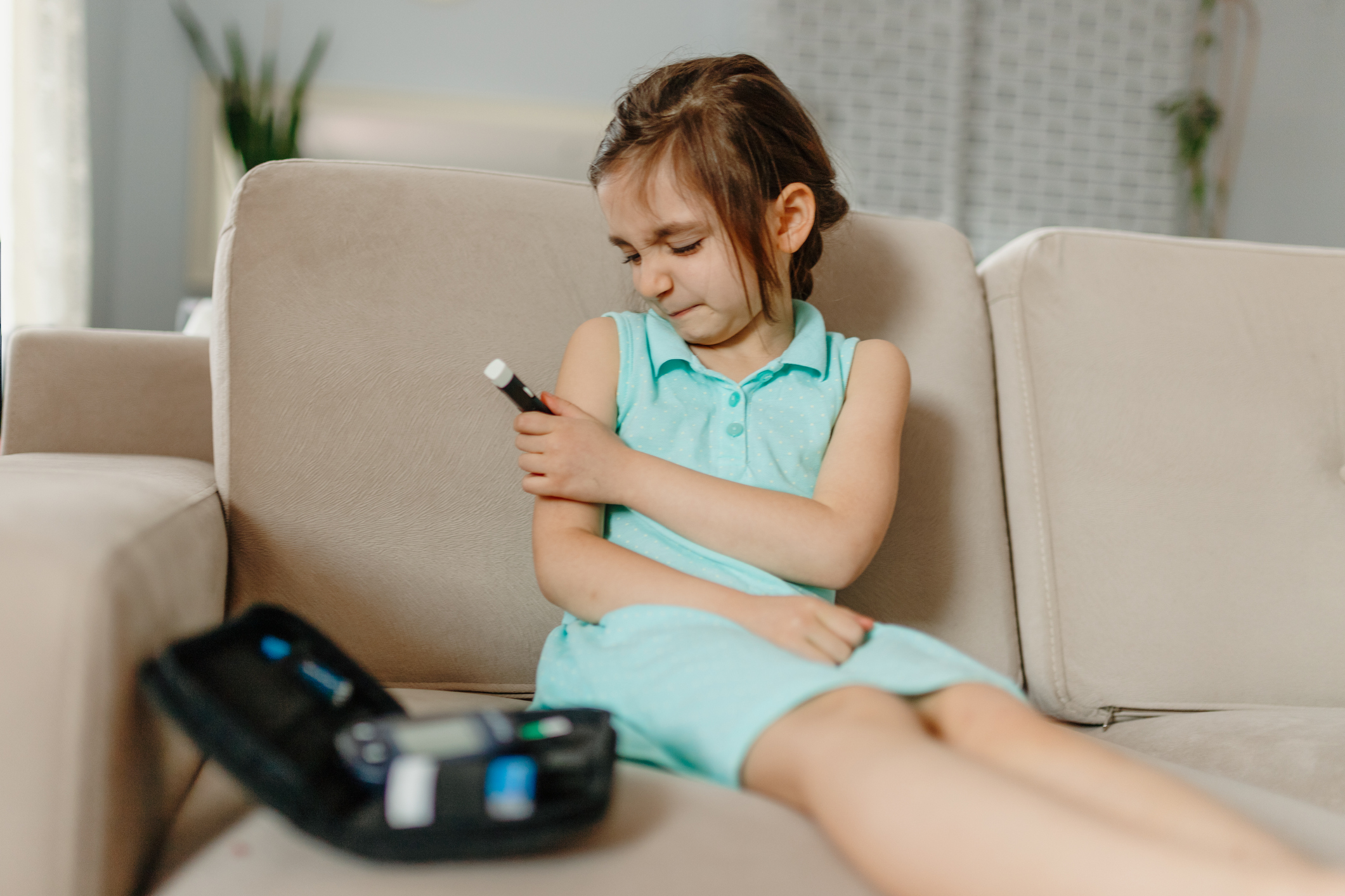 Little girl  is checking his blood sugar level