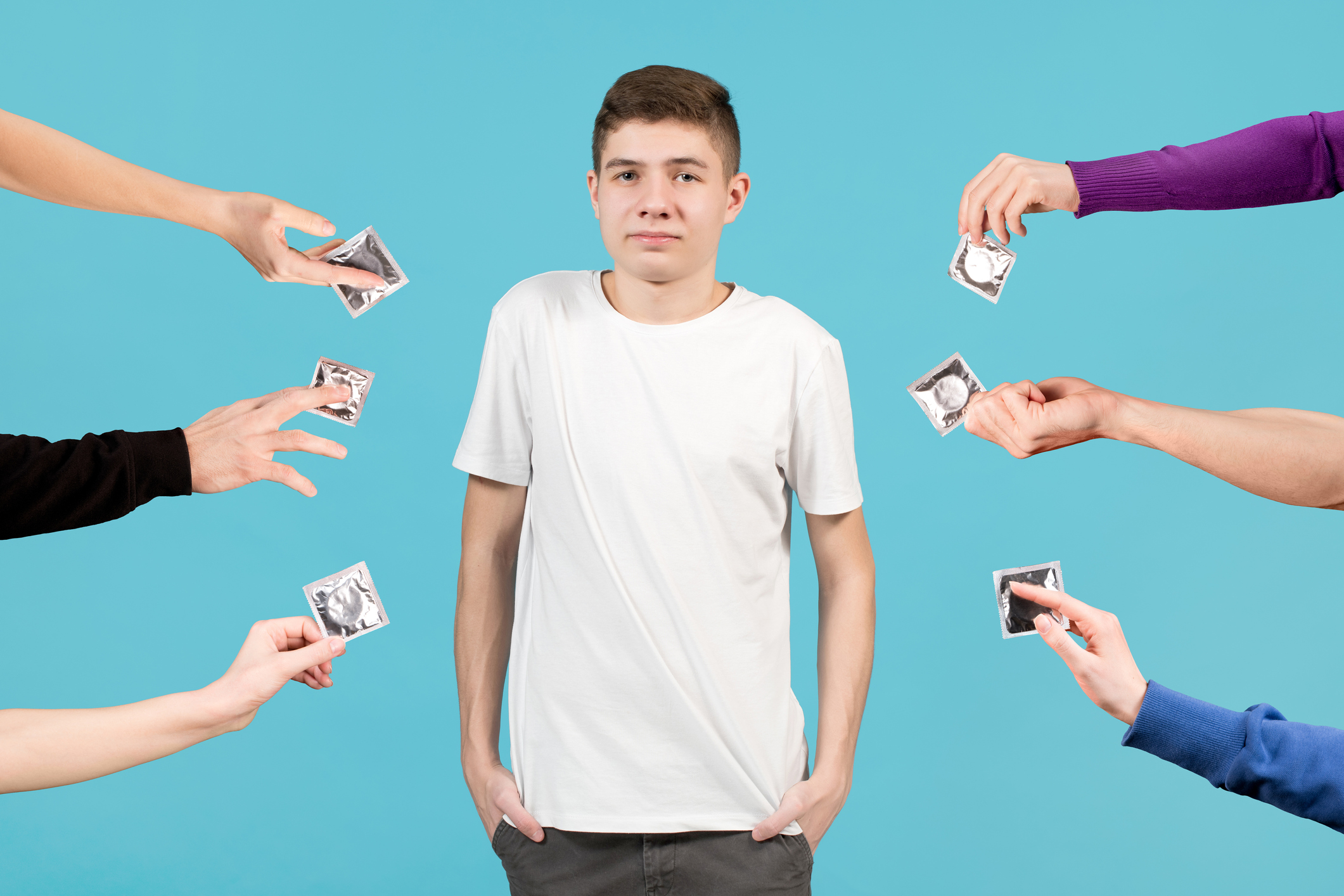 A teenager in a white T-shirt looks uncertainly forward