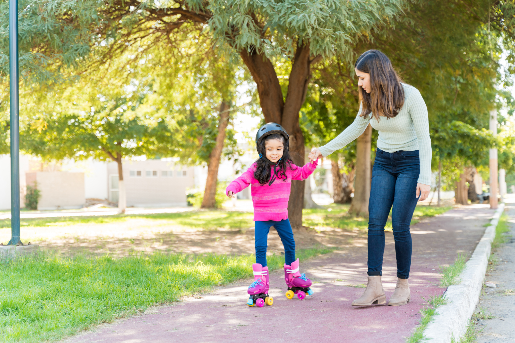 Woman Teaching Girl To Skate