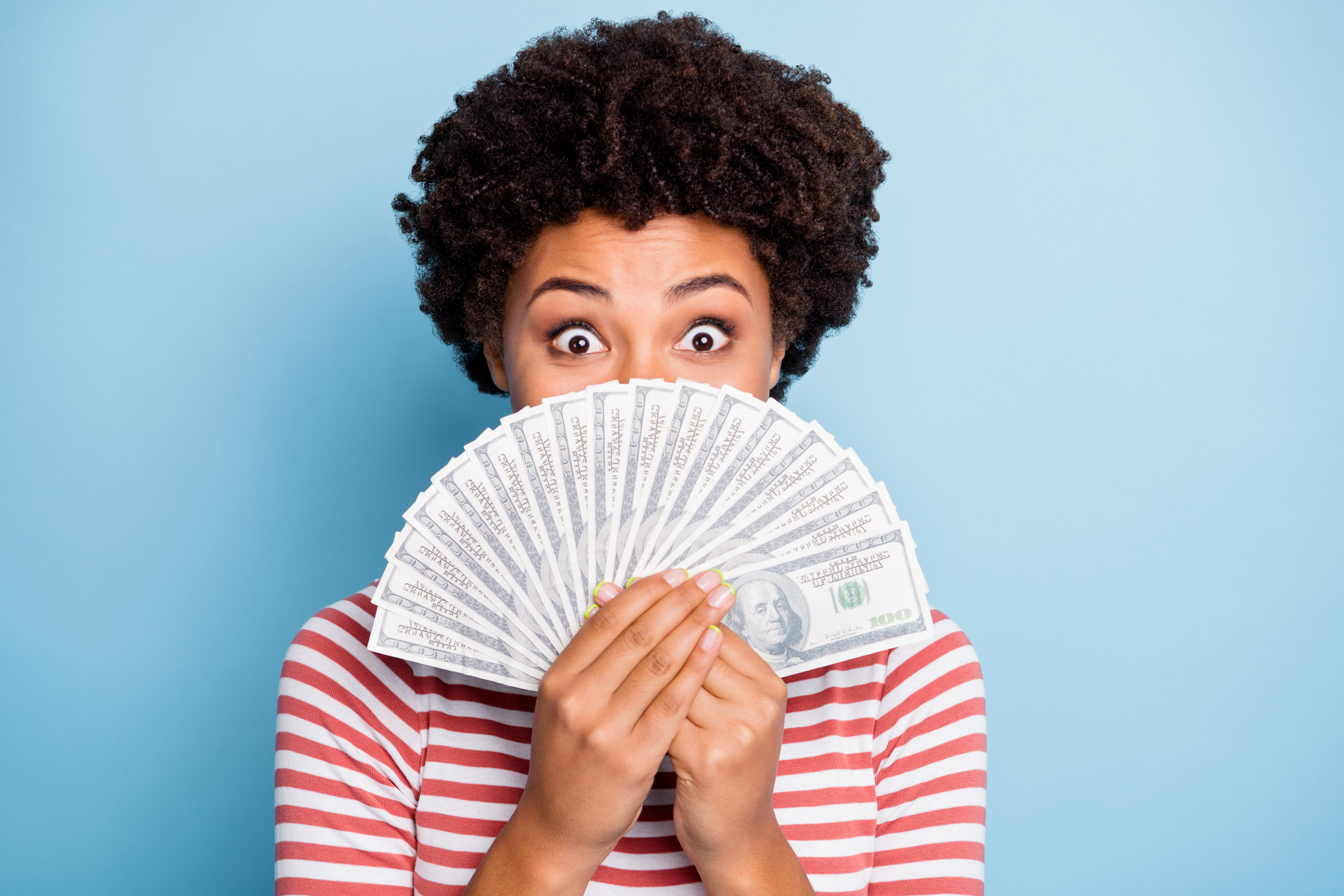 Close up portrait of cheerful positive cute curly wavy nice pretty youngster having gained victory at lottery expressing amazement on face isolated pastel blue color background