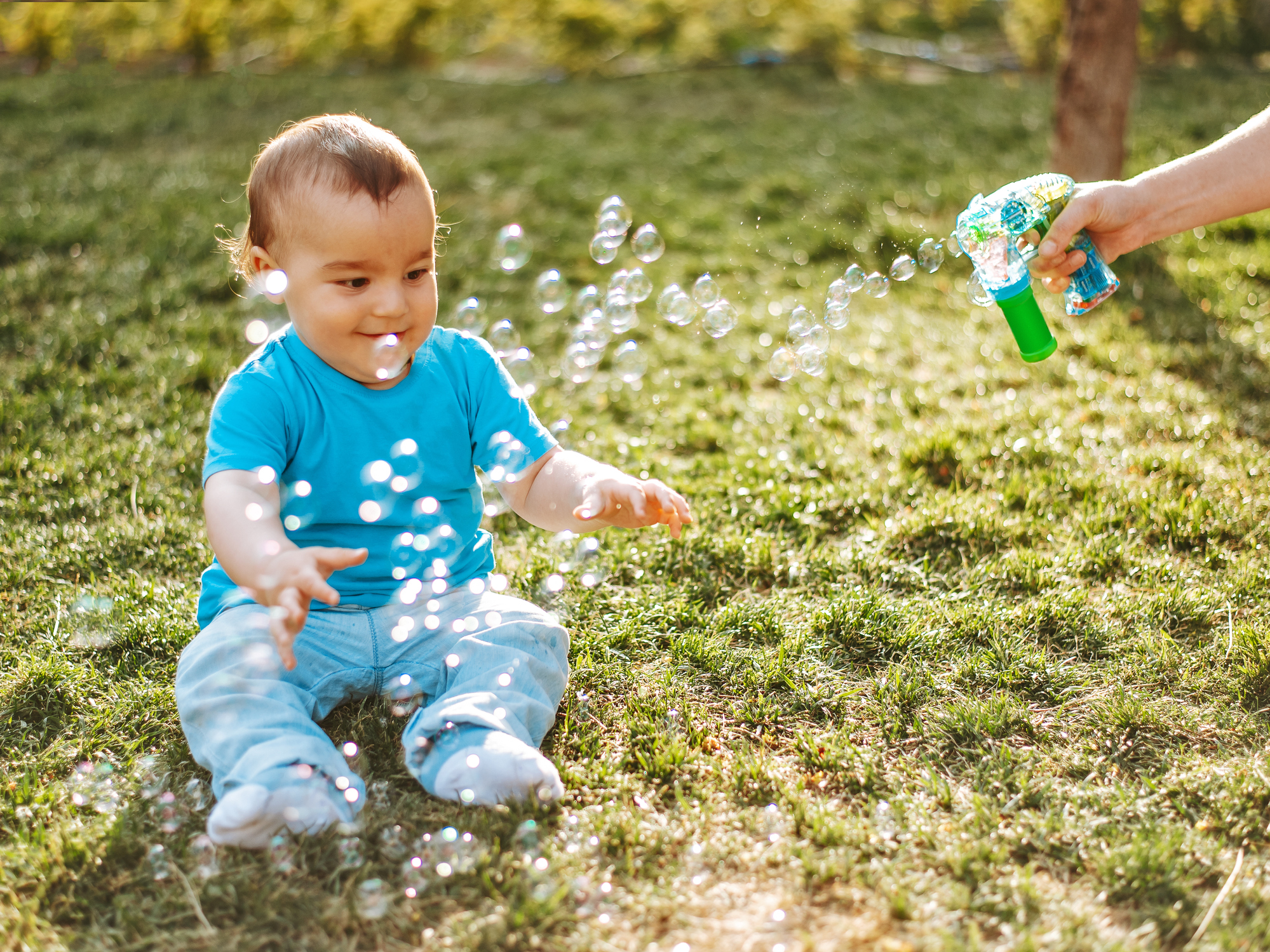 Baby boy playing with soap bubbles