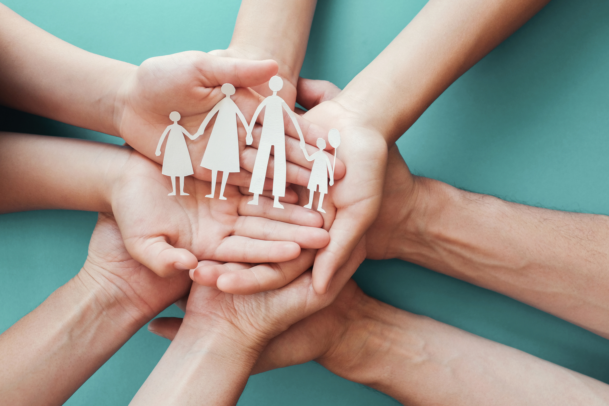 Adult and children hands holding paper family cutout, family home, foster care, homeless charity support concept, family mental health, international day of families