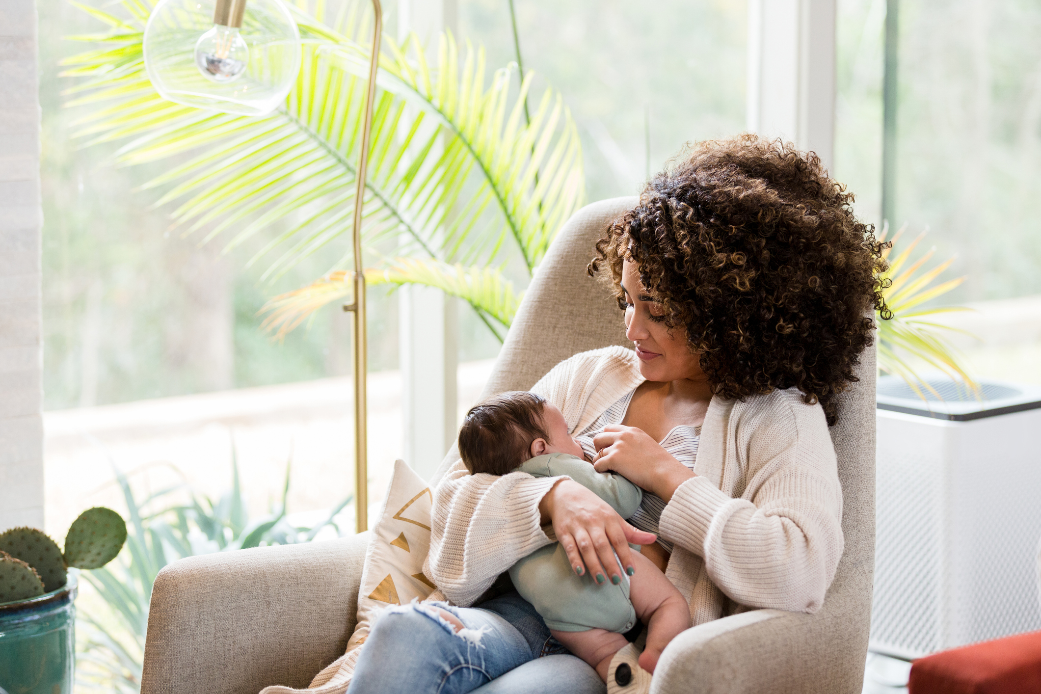 Mom breastfeeds newborn baby