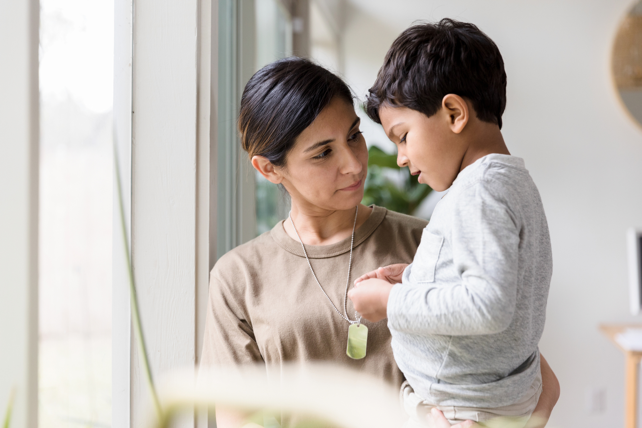 Soldier mother listens as young son talks about her deployment