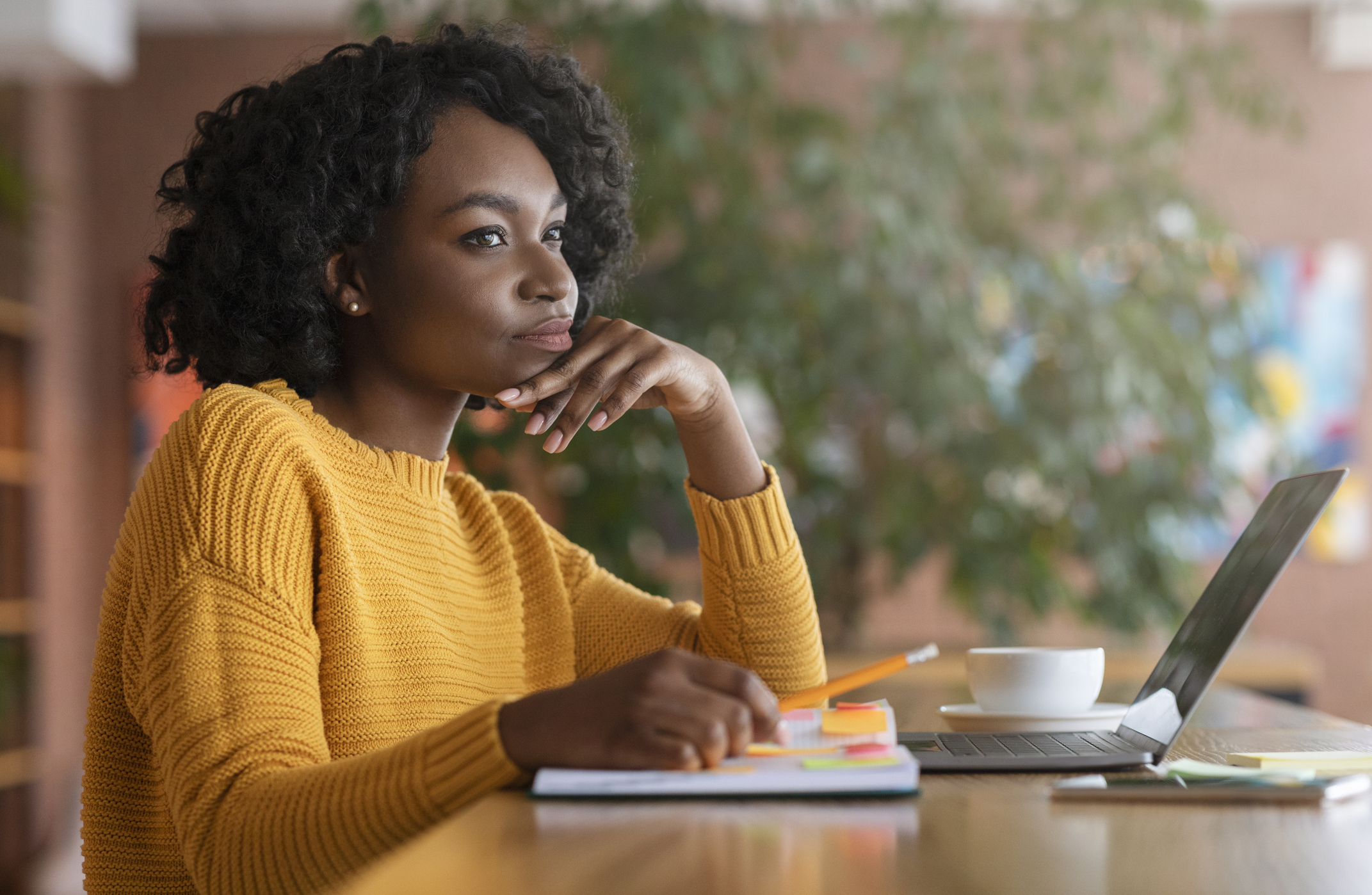 Thoughtful afro woman looking for new job online