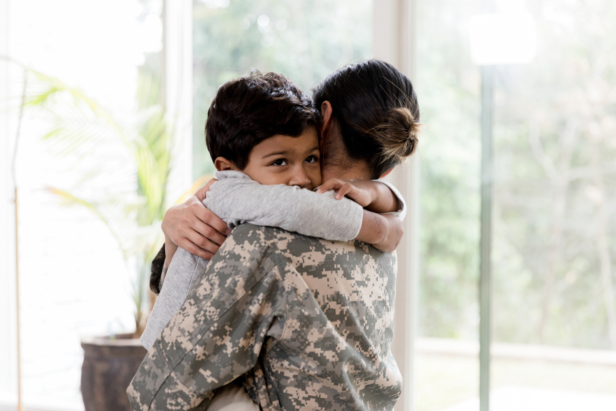 Sad little boy tells his military mom goodbye