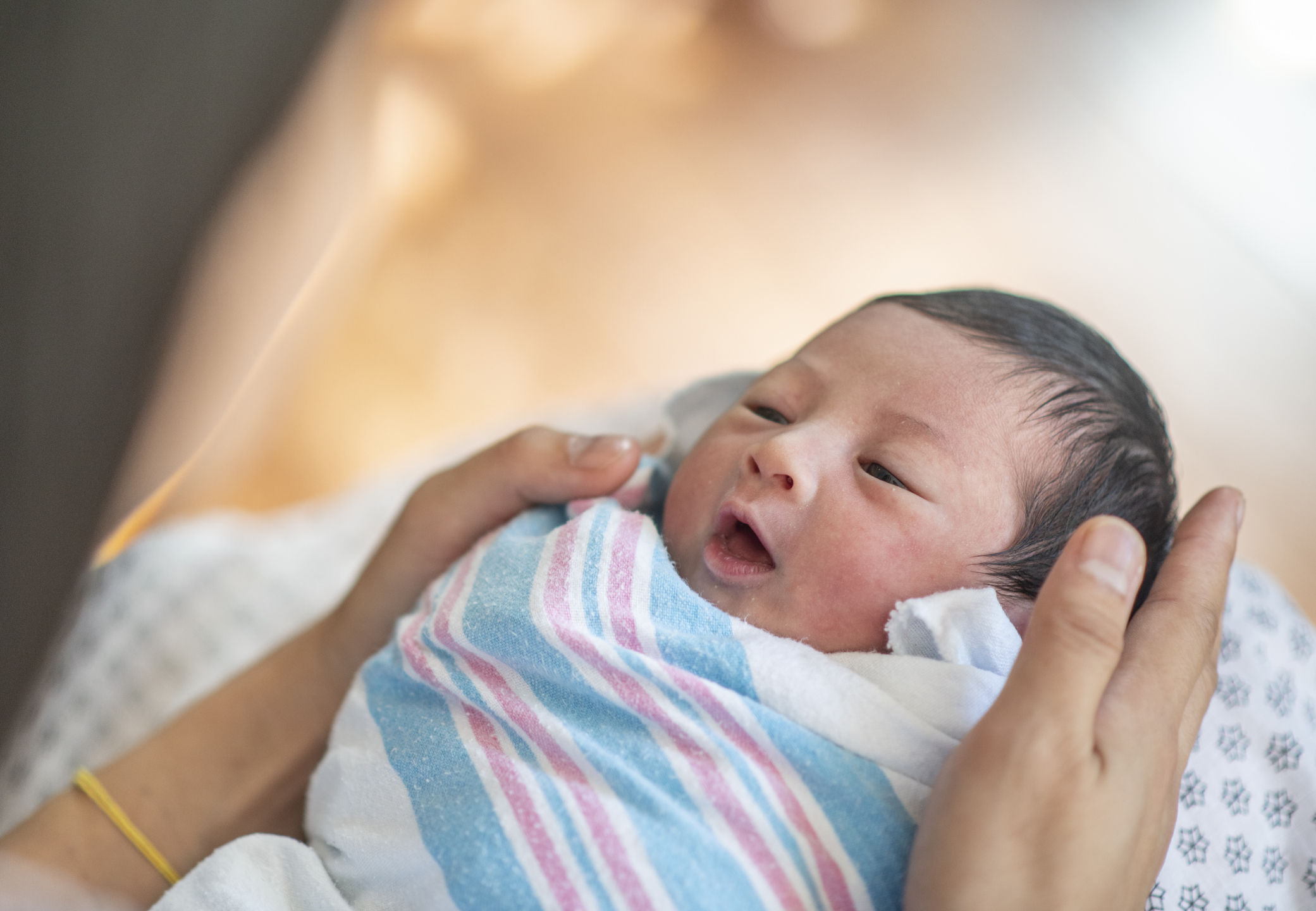 Swaddled Newborn Baby and Mother stock photo