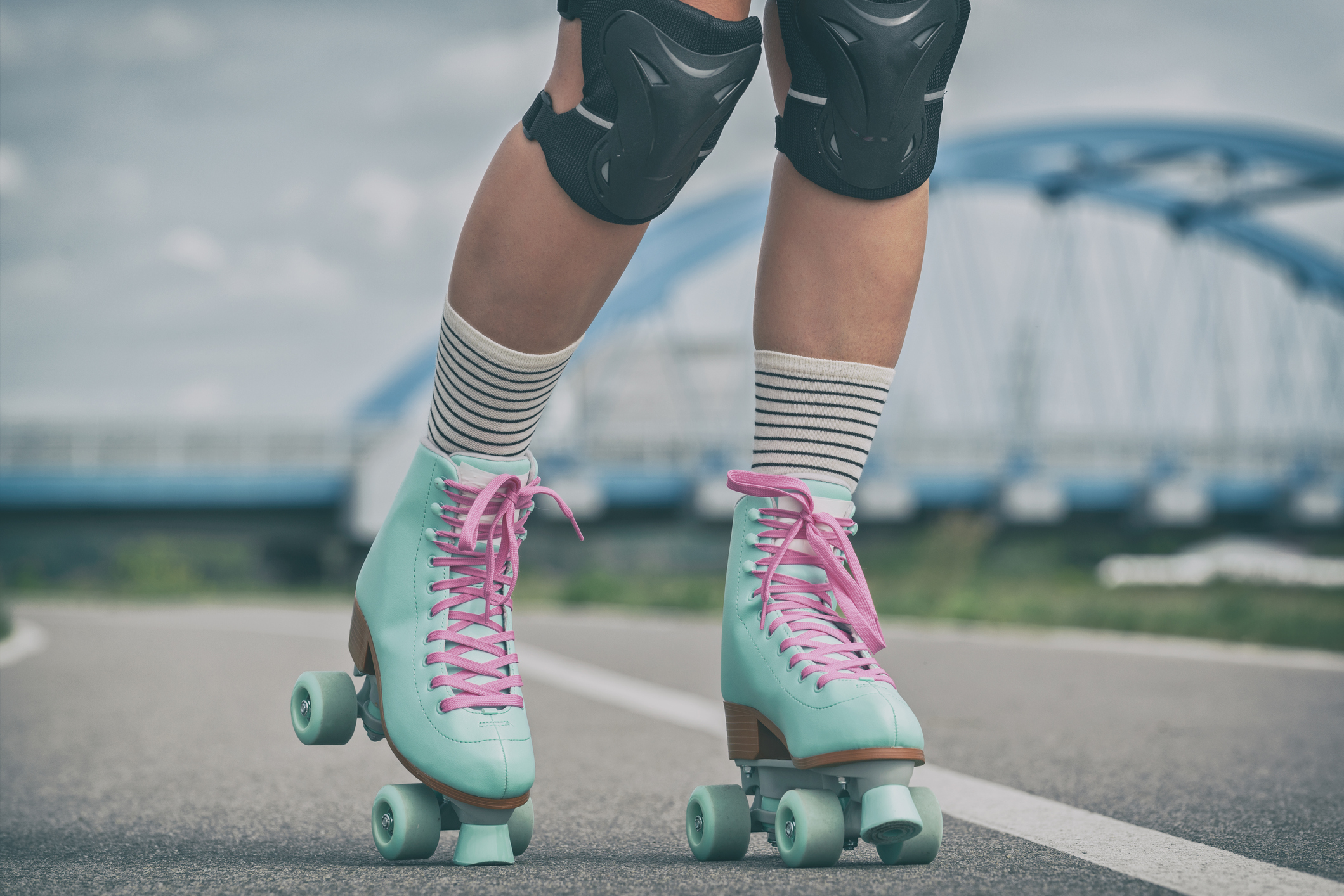 Woman rollerskater wearing knee protector pads