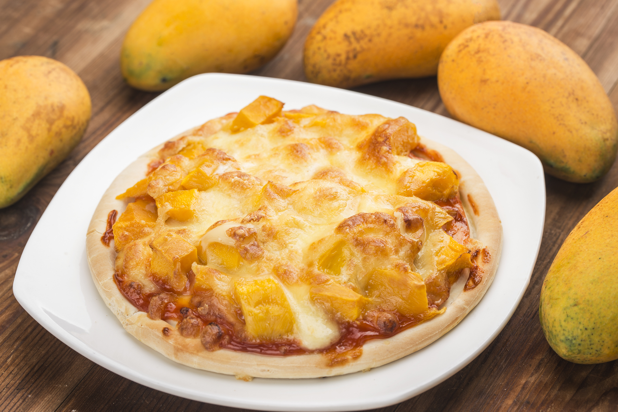 Fresh mango pizza on the table