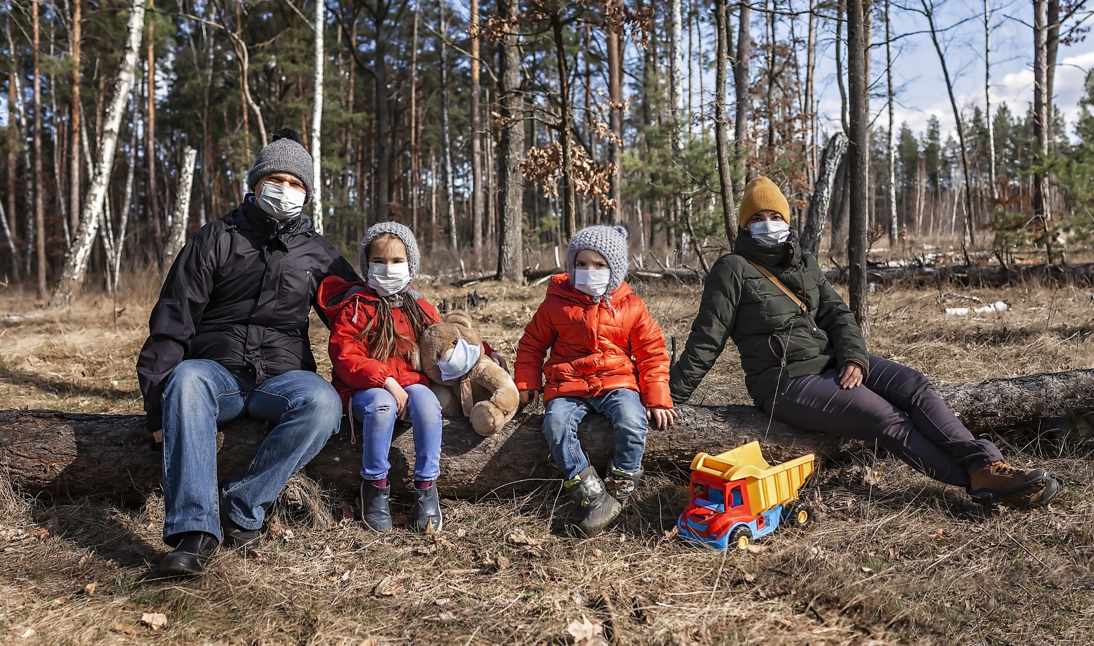 Family portrait wearing respirator masks in early spring, outdoor, guideline in quarantine time