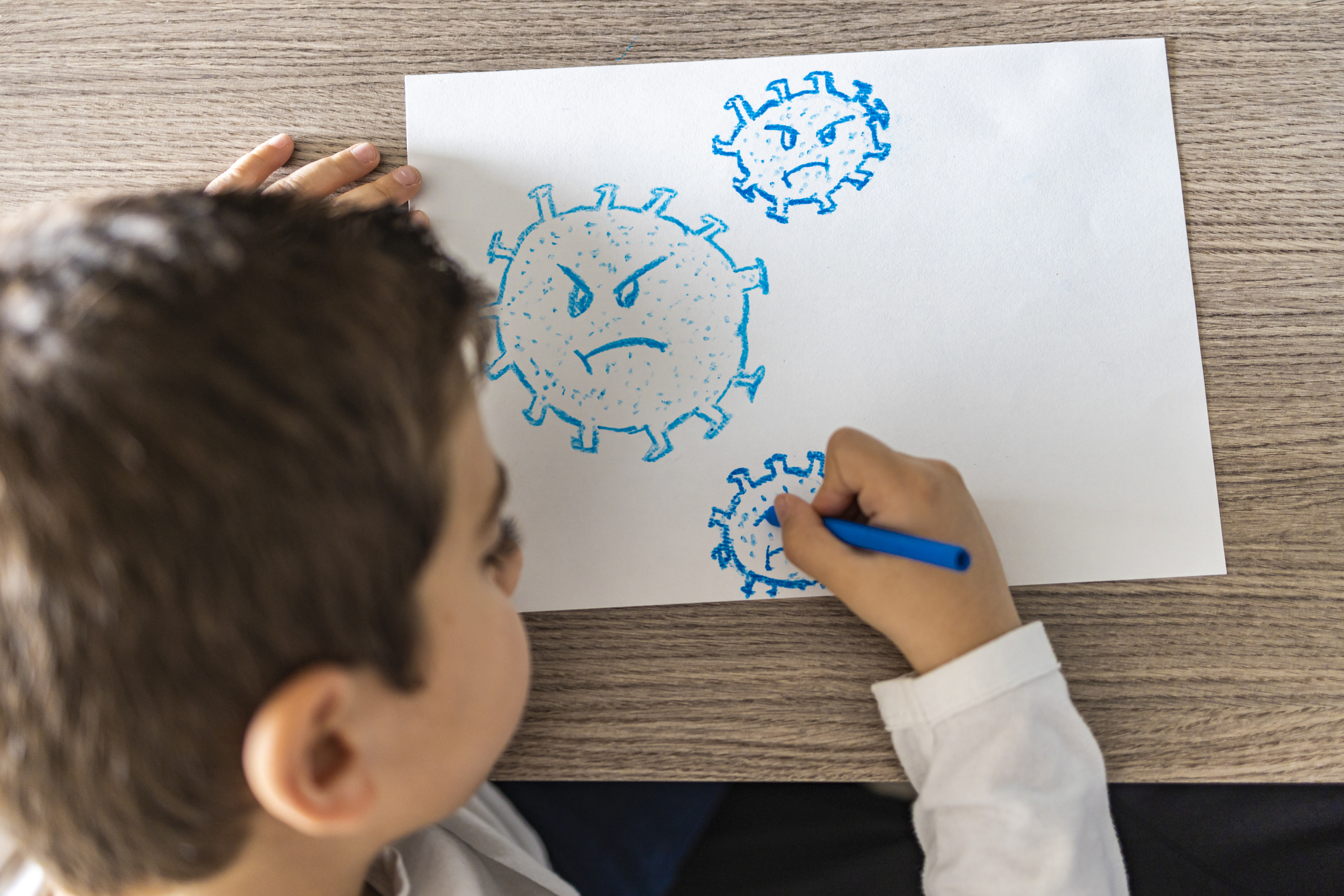 Little kid drawing a coronavirus