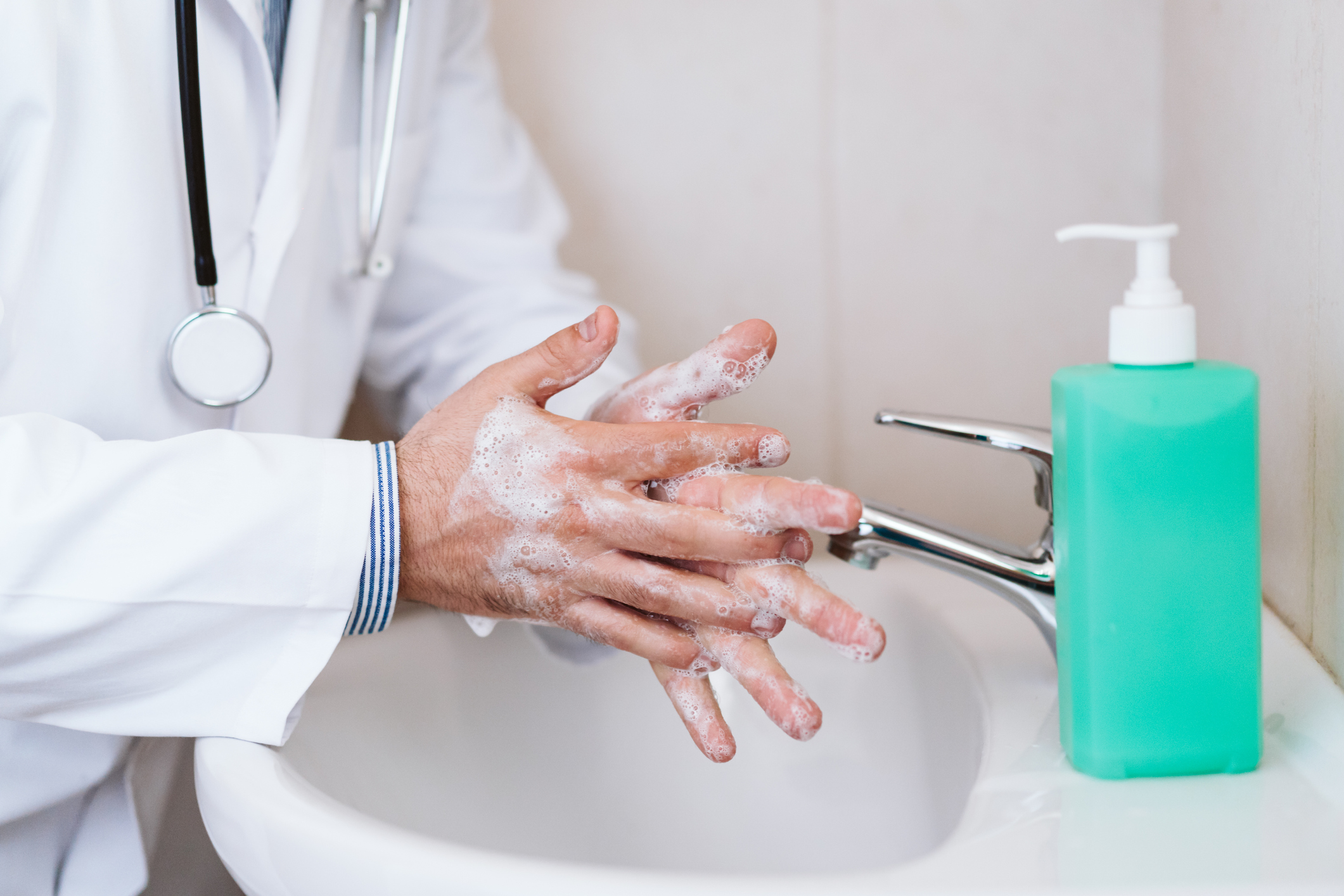 doctor man washing hands with disinfectant soap. Hygiene and Corona virus Covid-19 concept