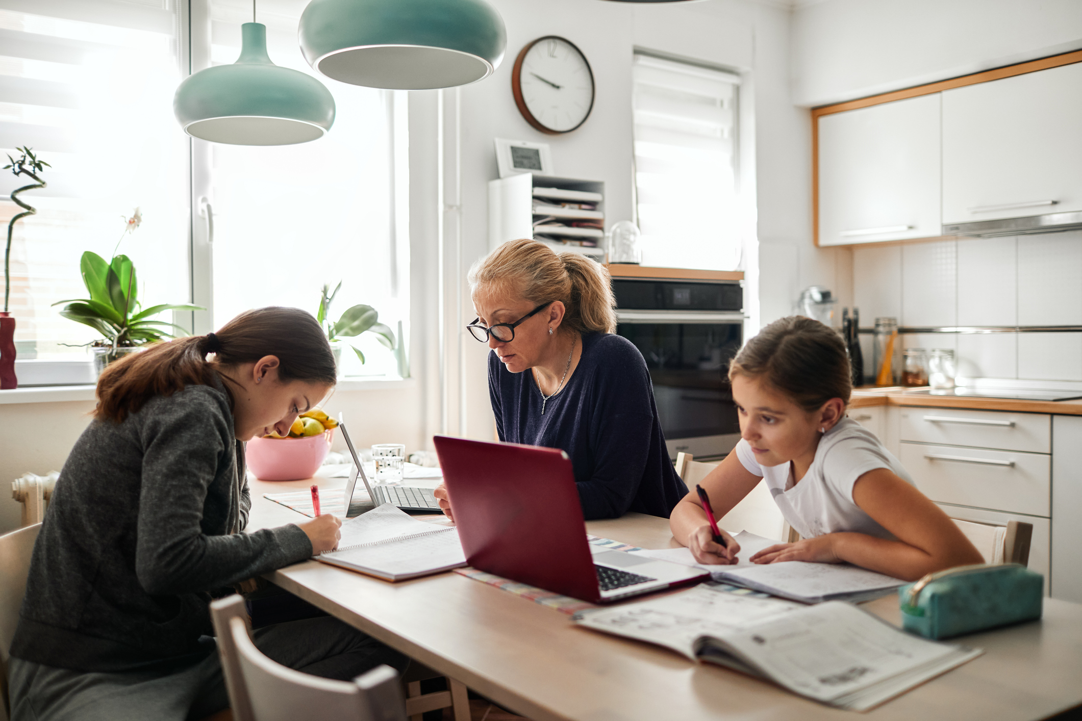 Homeschooling - Mother Helping To Her Daughters To Finish School Homework During Coronavirus Quarantine