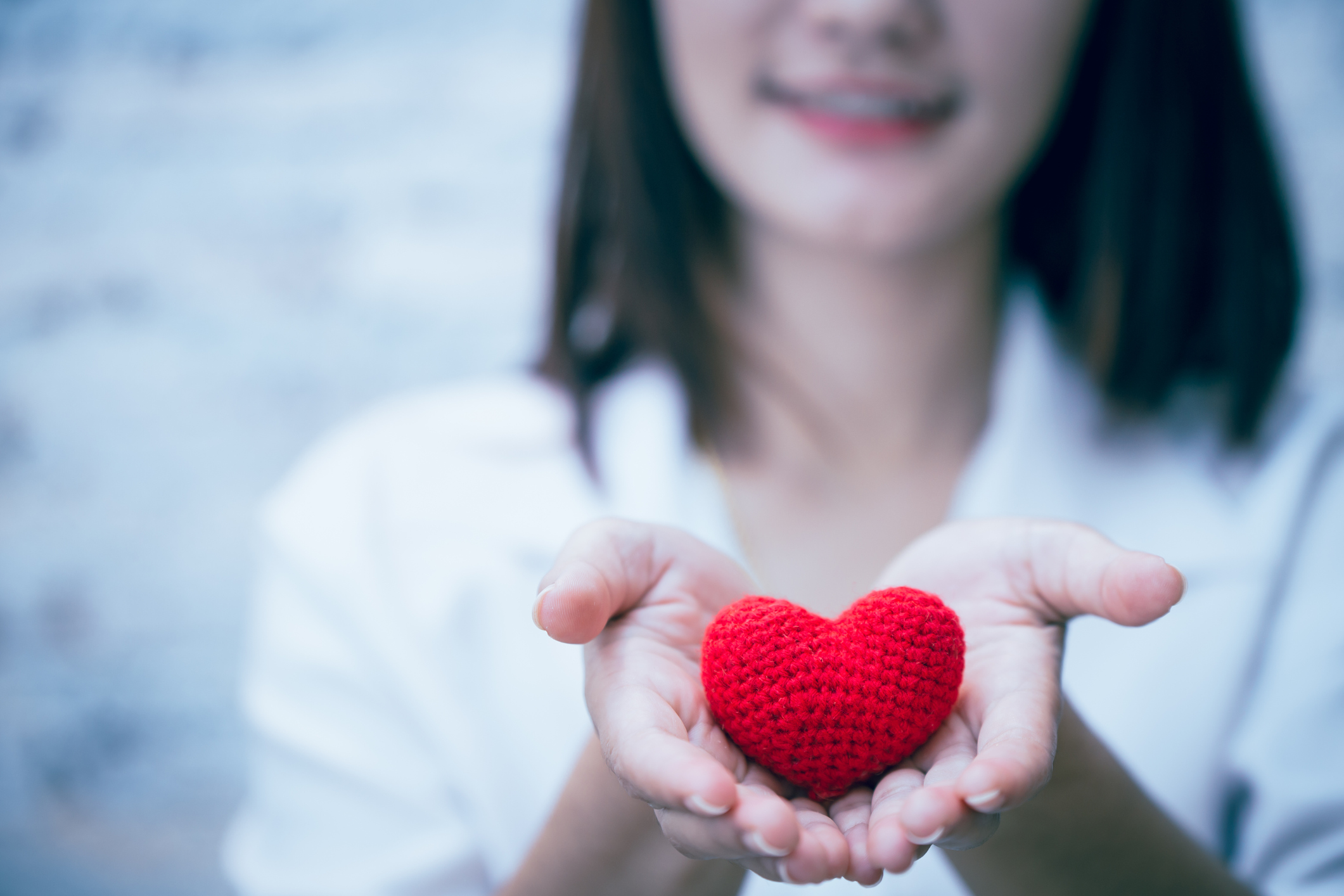 cute girl teen giving love heart and smile