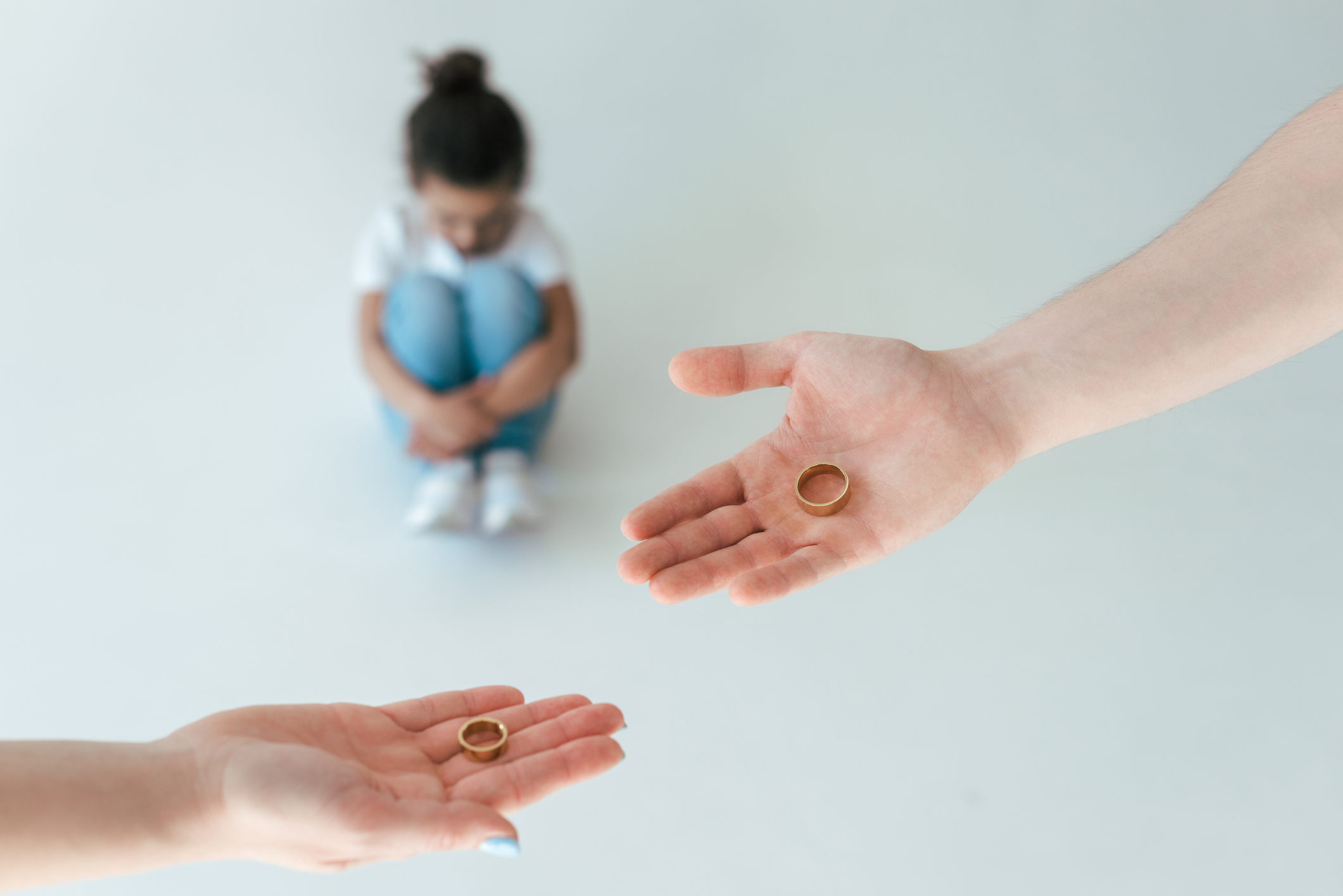 selective focus of divorced man and woman holding engagement rings near african american daughter