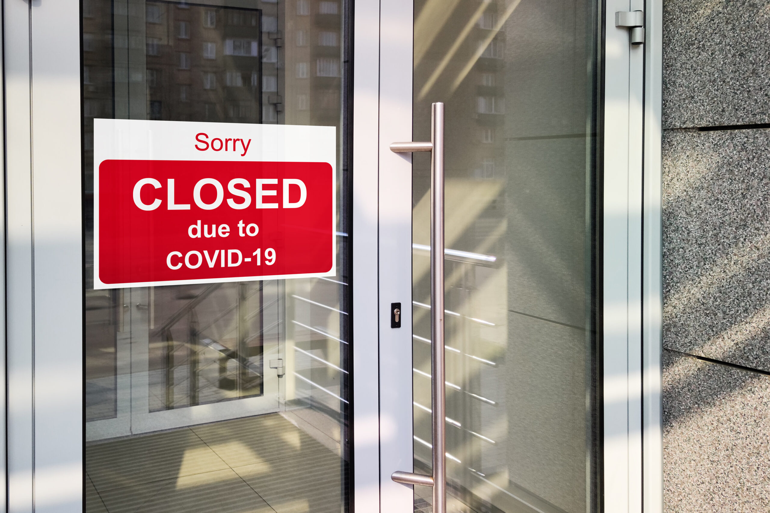 Business center closed due to COVID-19, sign with sorry in door window. Stores, restaurants, offices, other public places temporarily closed