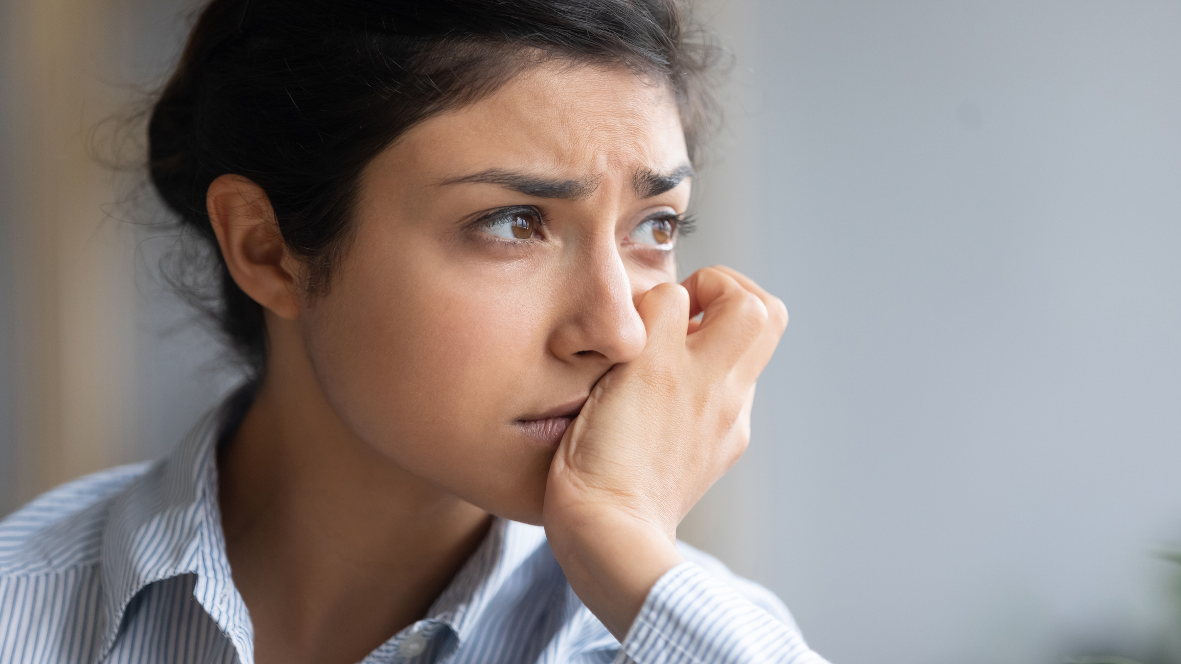 Close up depressed unhappy Indian woman thinking about problems