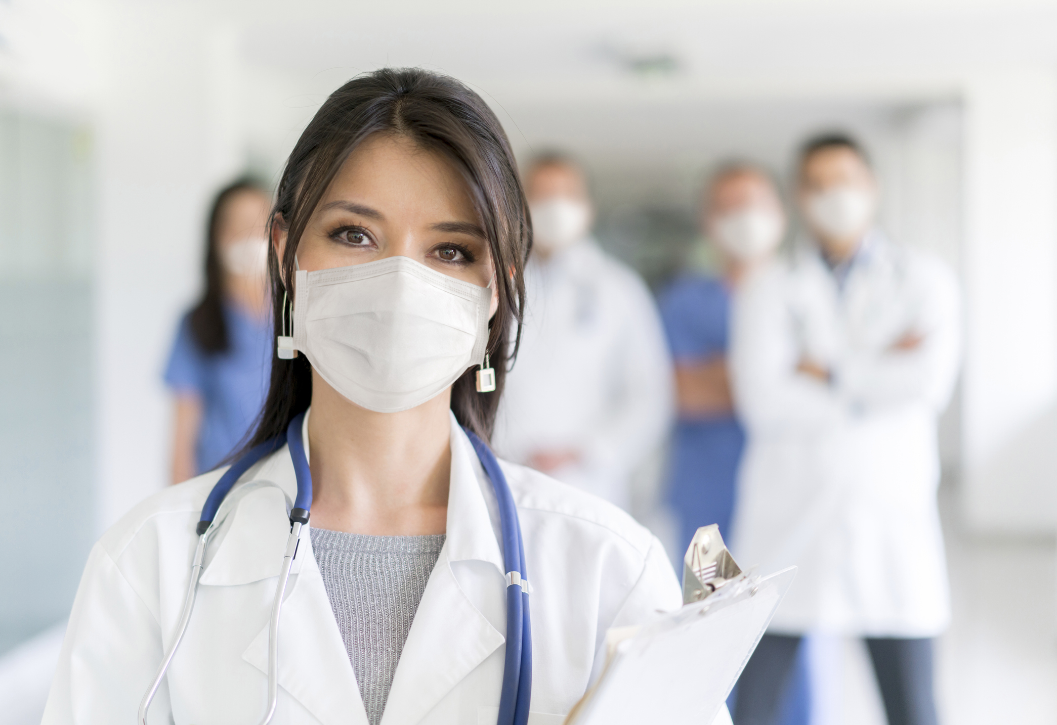 Doctor working at the hospital wearing a facemask to avoid COVID-19