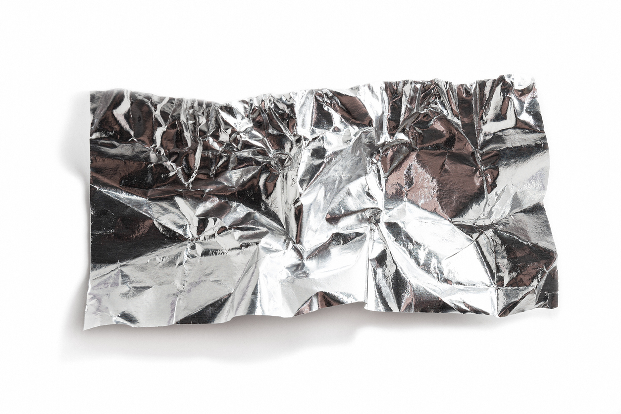 White shiny aluminum foil wrap on a white background.