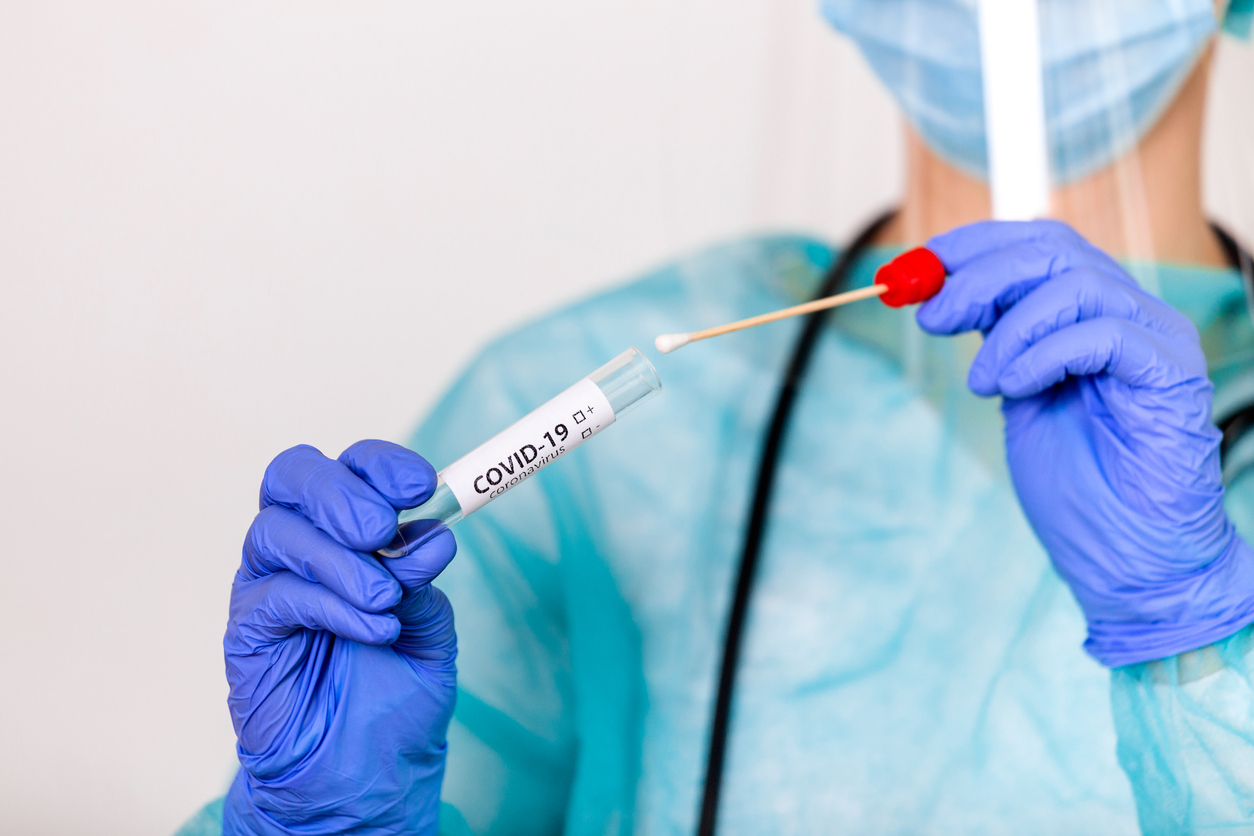 Lab technician holding swab collection kit,Coronavirus COVID-19 specimen collecting equipment,DNA nasal and oral swabbing for PCR polymerase chain reaction laboratory testing procedure and shipping