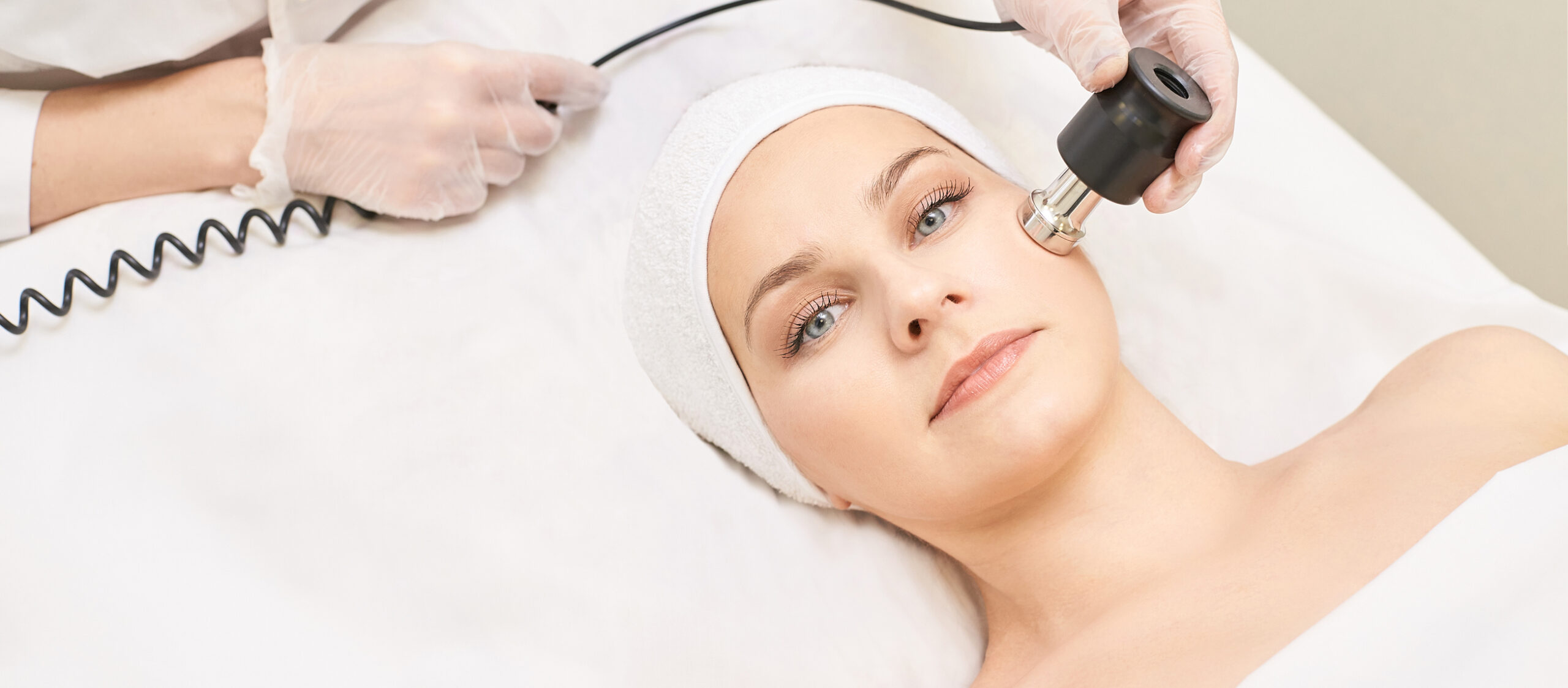 Electroporation woman face treatment. Facial rejuvenation therapy. Cosmetology skin spa equipment. Rf lifting. Massage device