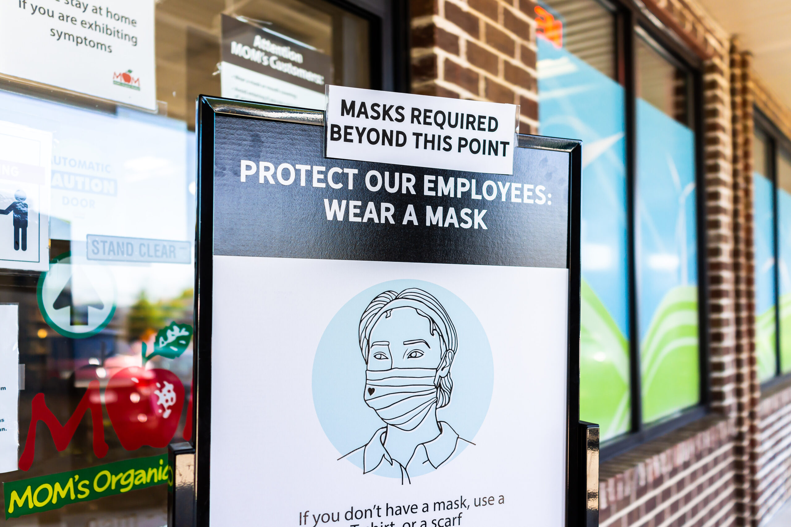 Mom's Organic Market store in Virginia with sign to wear face mask covering beyond this point corona virus