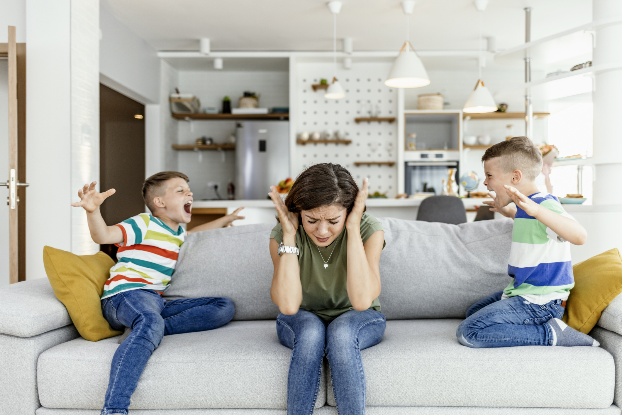 Unhappy mother having problem with noisy naughty two kids